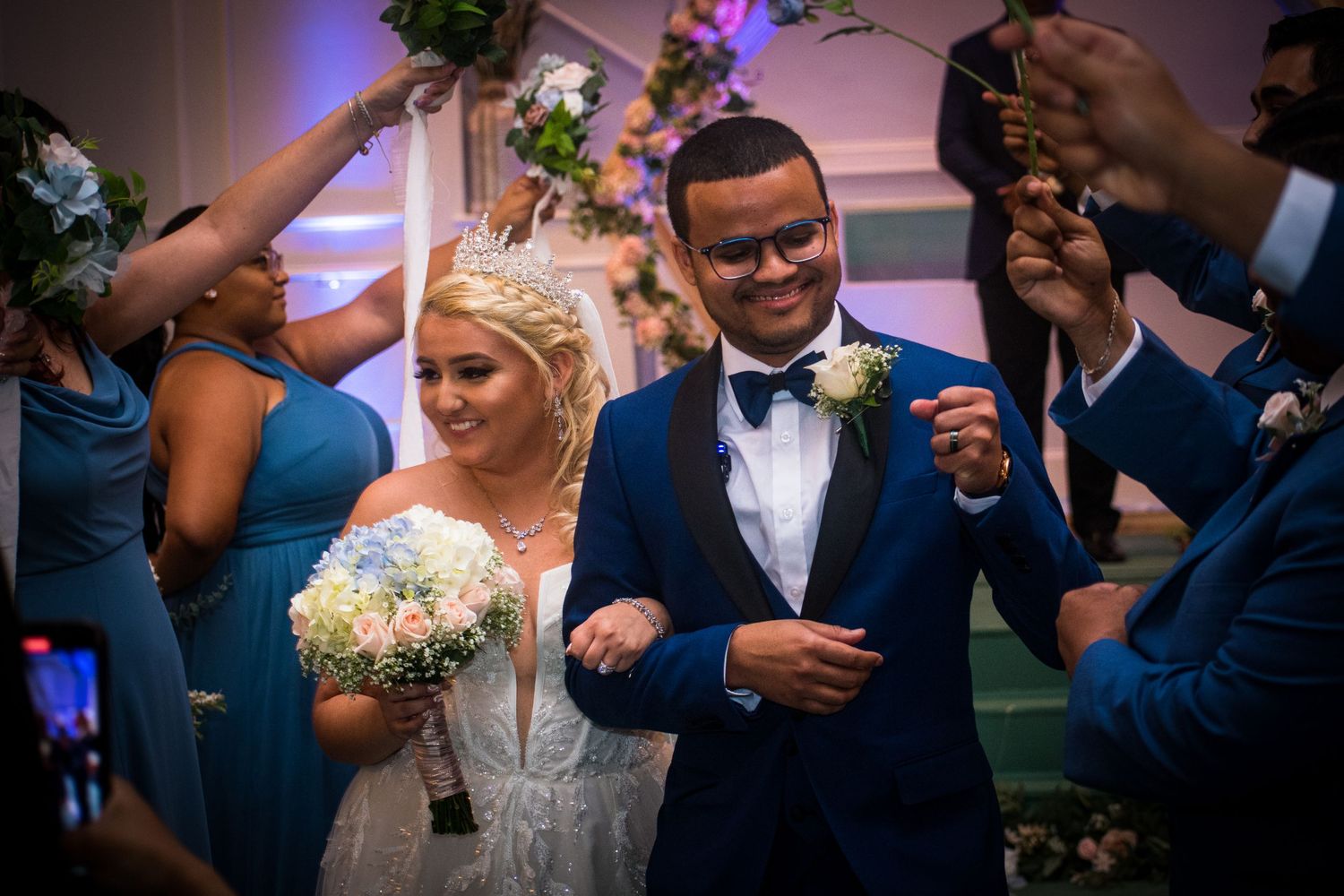Wedding celebration with guests holding sparklers during reception festivities.