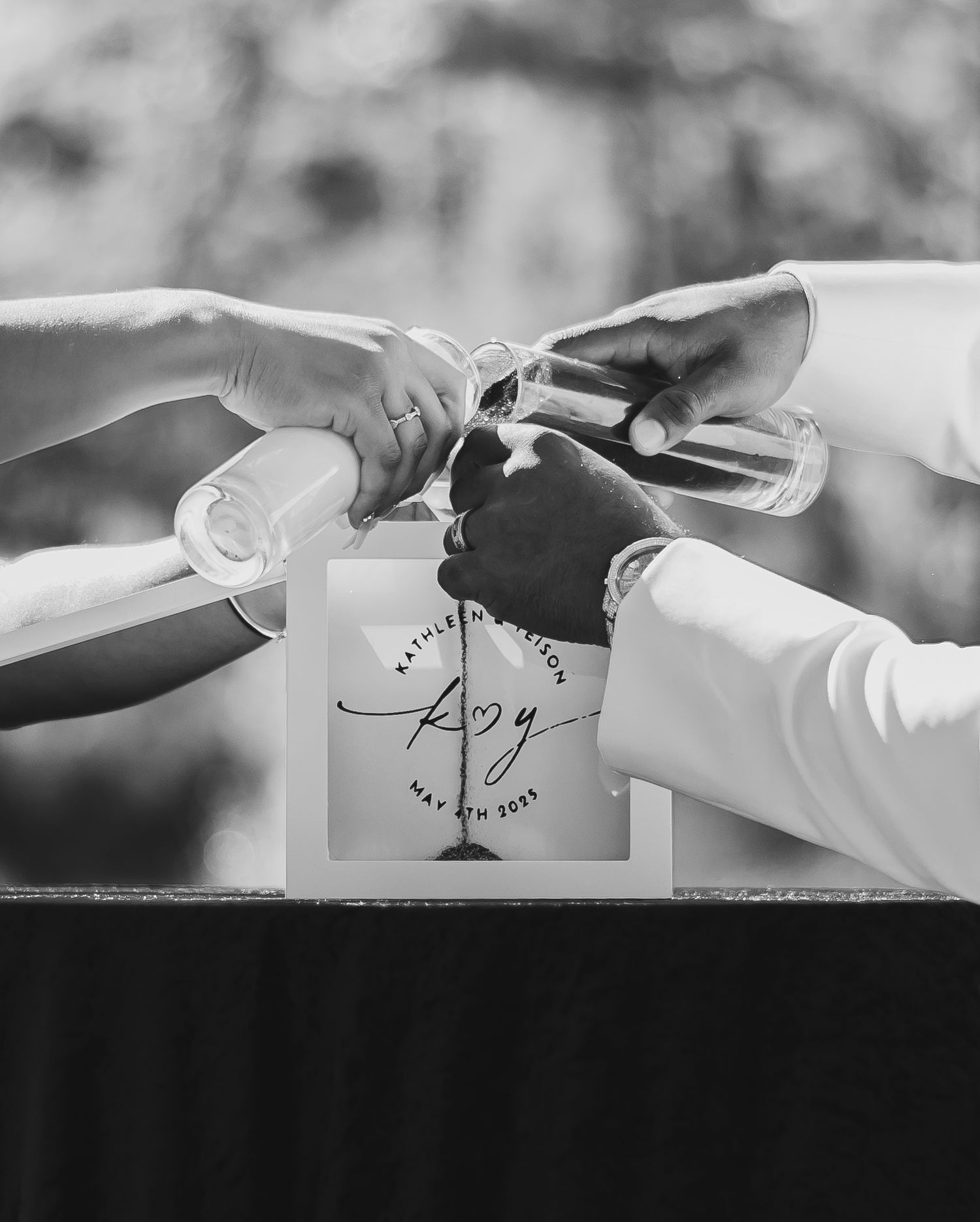 Black and white artistic photographs of hands placing origami paper cranes in different positions.
