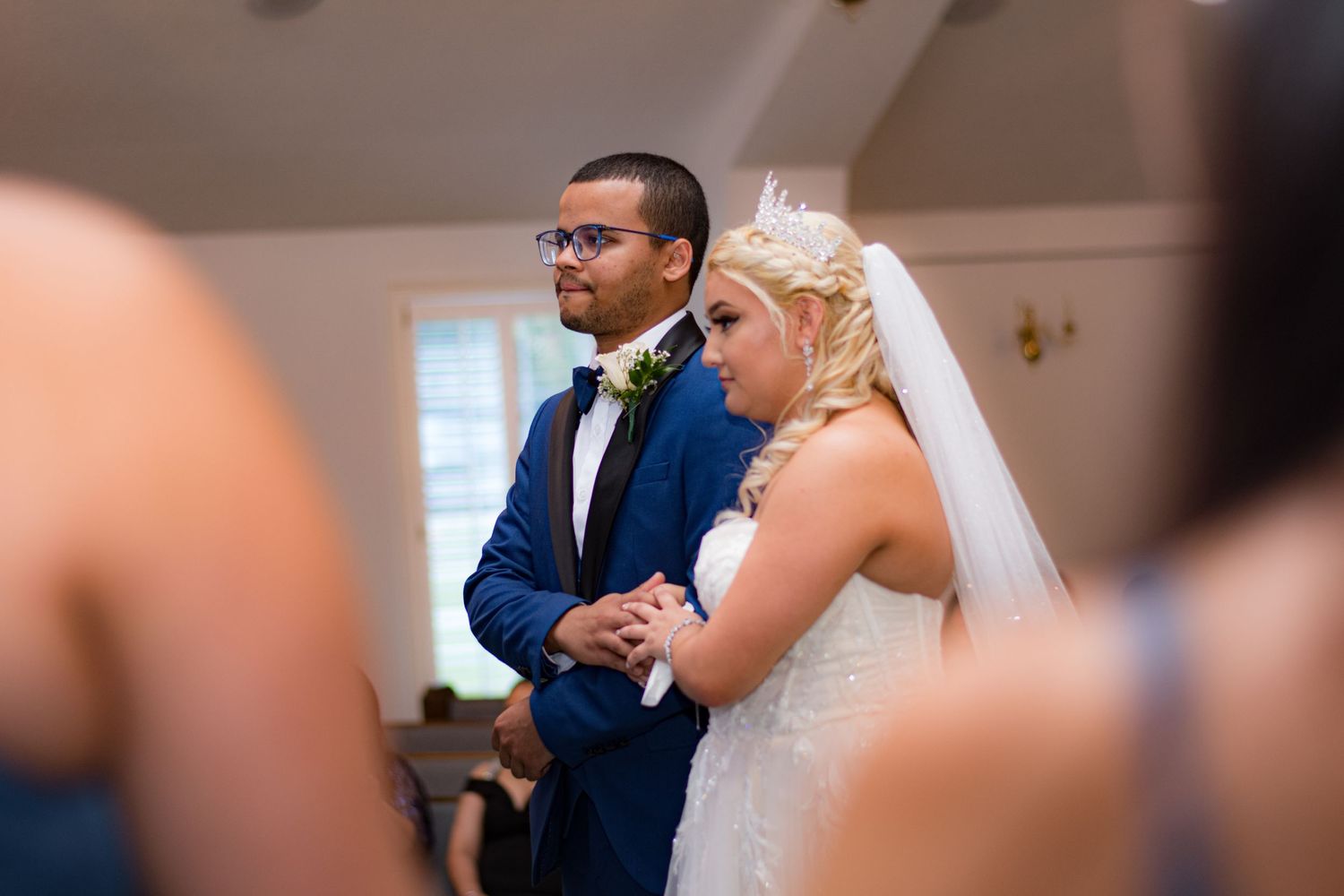 Wedding ceremony moment captured in an indoor venue with natural lighting.