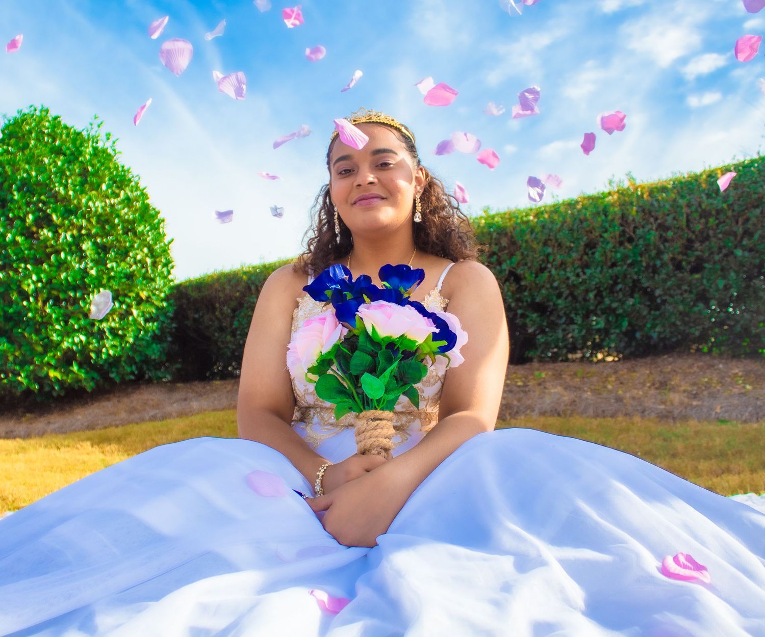 Birthday celebration in garden setting with blue roses and floating petals.