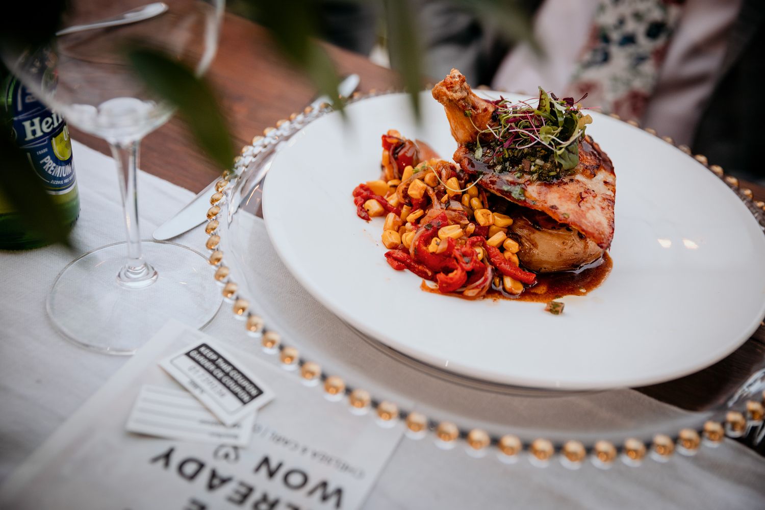 A Vows and Vines wedding fine dining experience showcasing multiple elegant plated dishes on white plates with garnishes and sauces.