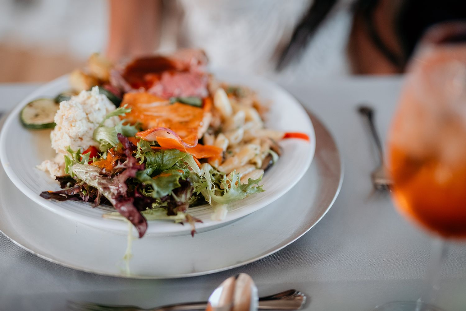 Elegant plated dishes served at an upscale restaurant with garnishes and artistic presentation.
