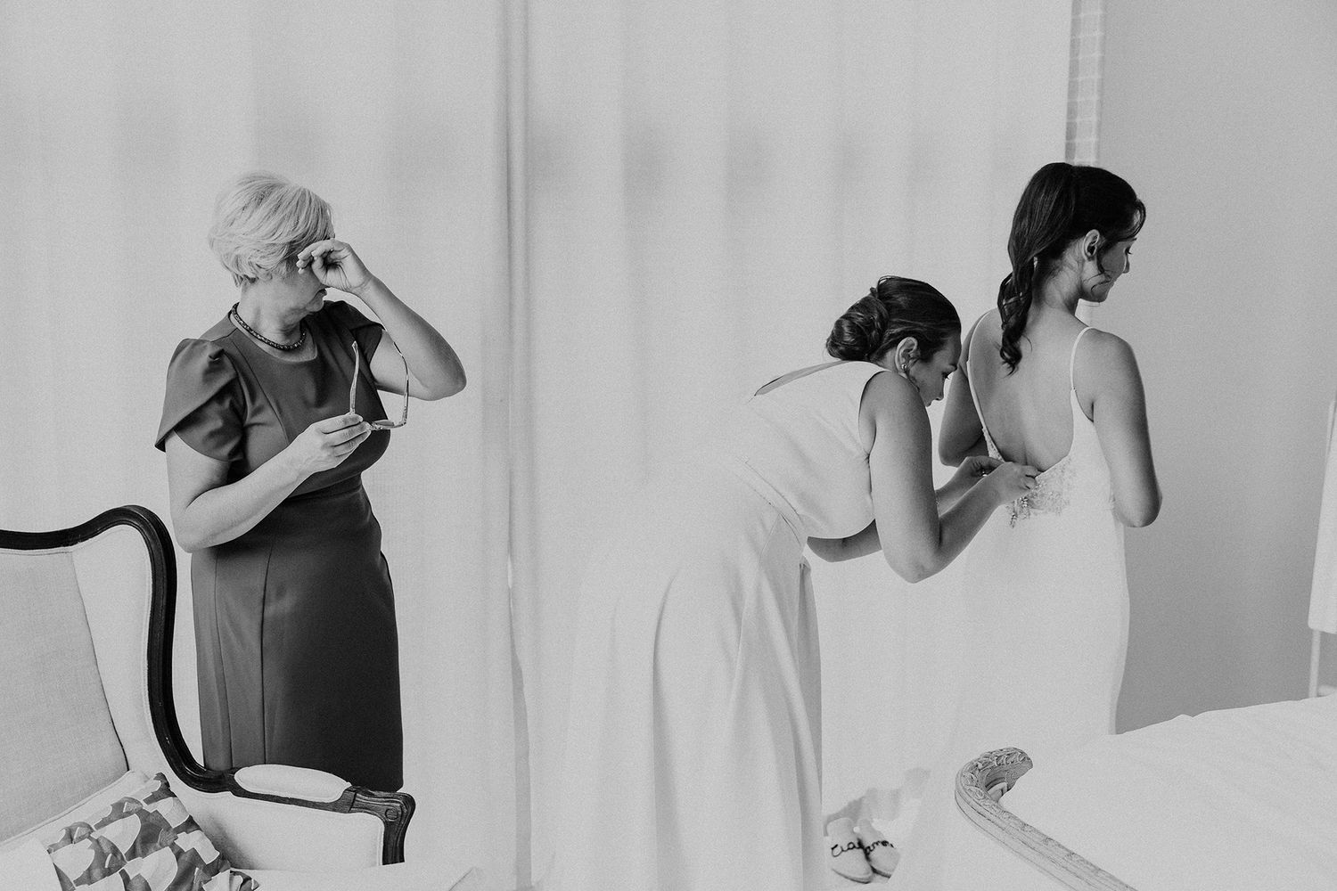 A series of black and white photo of a bride's maid helping a bride as the bride's mom sheds tears of joy.