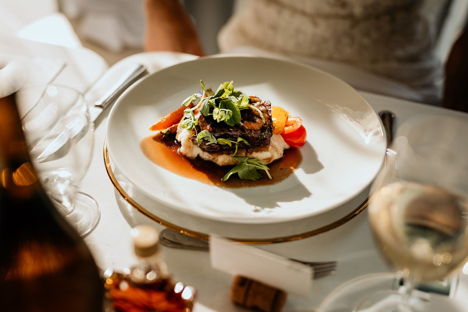 Elegant plated dishes being served at an upscale wedding at Summerhill Pyramid Winery in Kelowna, BC.