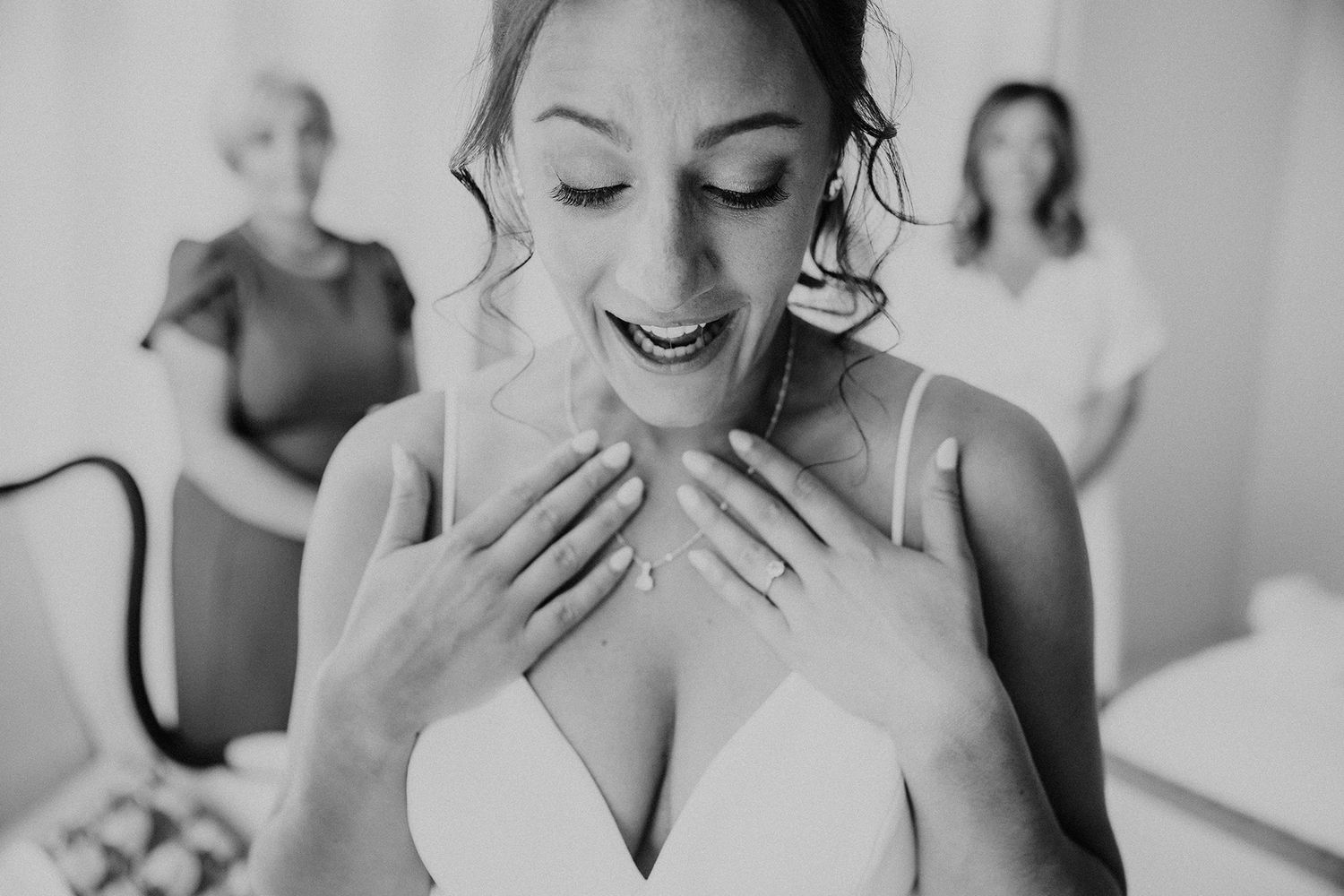 Black and white photo of an emotional bride getting ready on her wedding day.