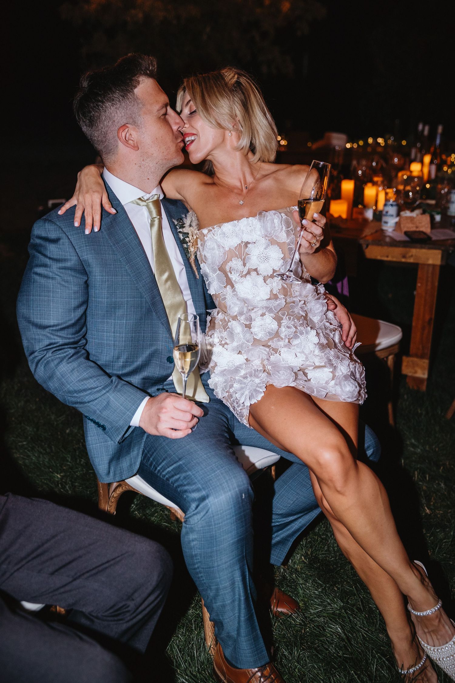A bride sits on her new husband's lap after a night of dancing at their wedding in Kamloops, BC.