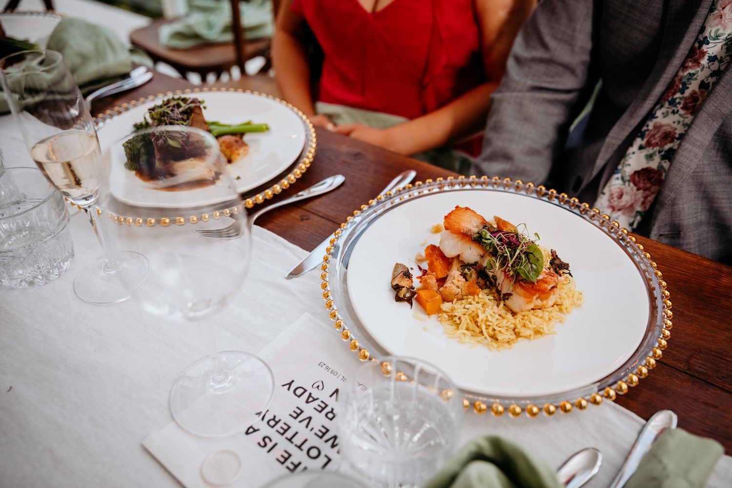 Wedding guests served beautifully plated dinners at Vows and Vines Vineyard wedding.