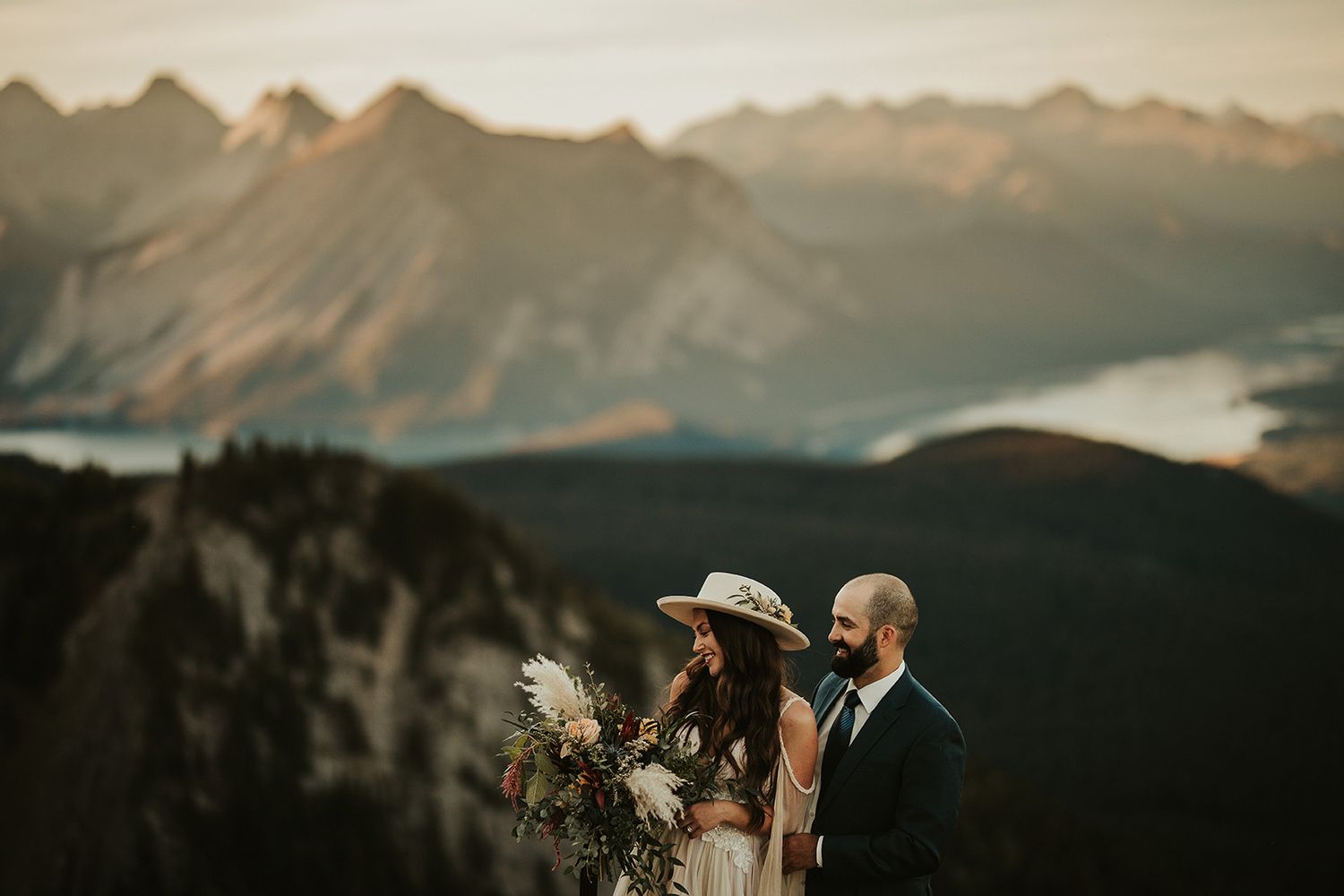 A scenic mountain wedding ceremony with a dramatic cloudy sky backdrop in the wilderness.