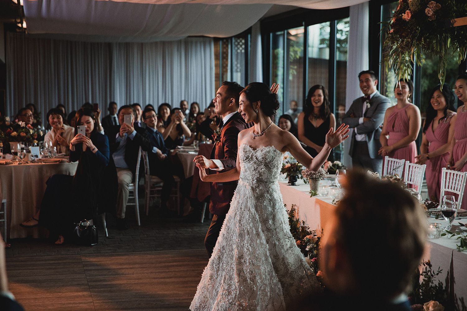 An Asian wedding couple dance under a dimly lit dance floor at their Summerhill Pyramid Winery wedding in Kelowna, BC.