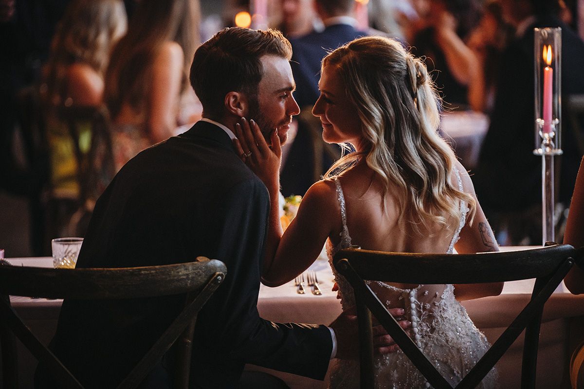 Just after kissing, a couple shares an intimate moment, looking into each others' eyes. 50th Parallel Winery wedding.