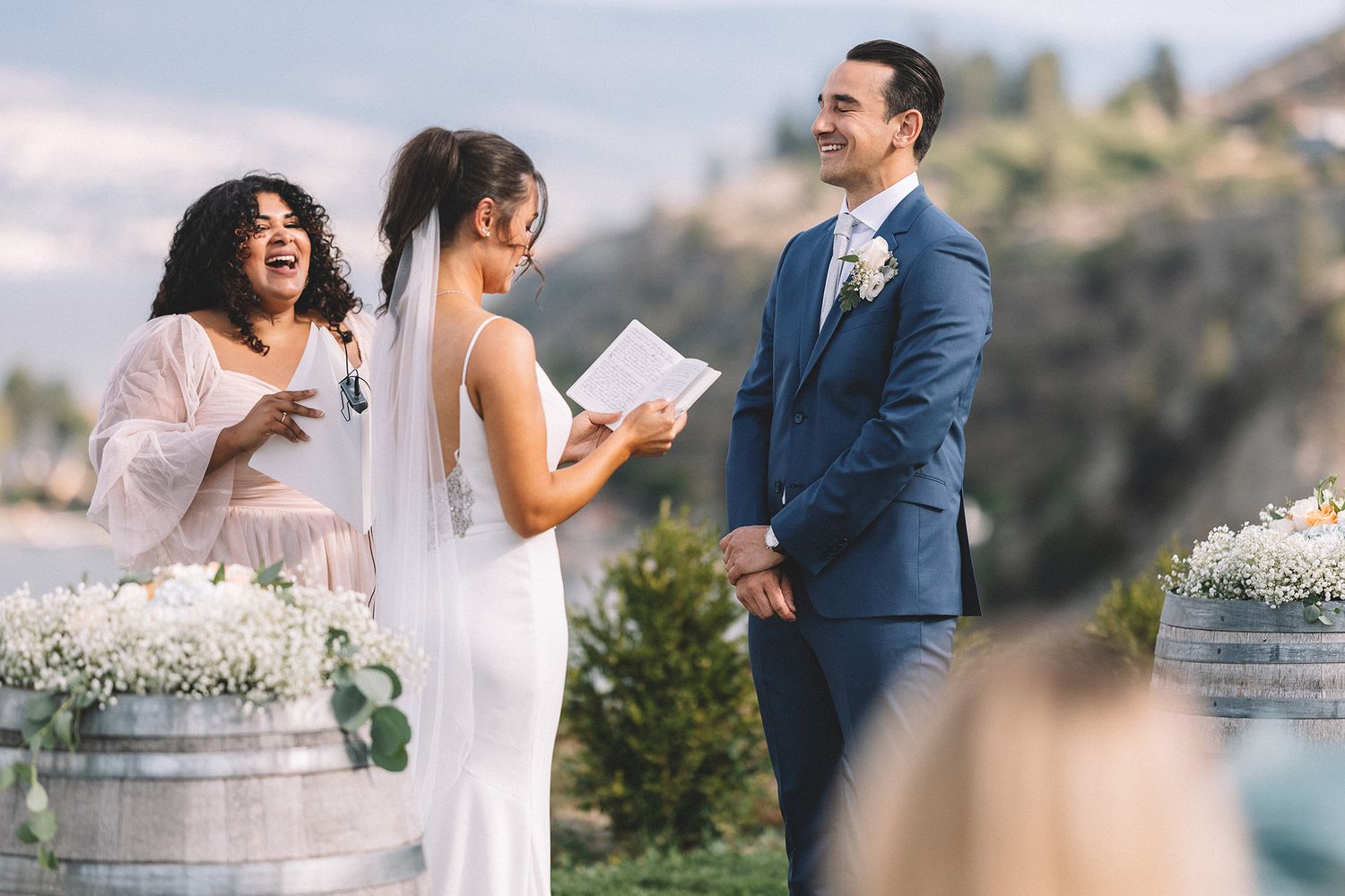 Elegant outdoor wedding celebration with mountain backdrop and natural decor featuring baby's breath floral arrangements.