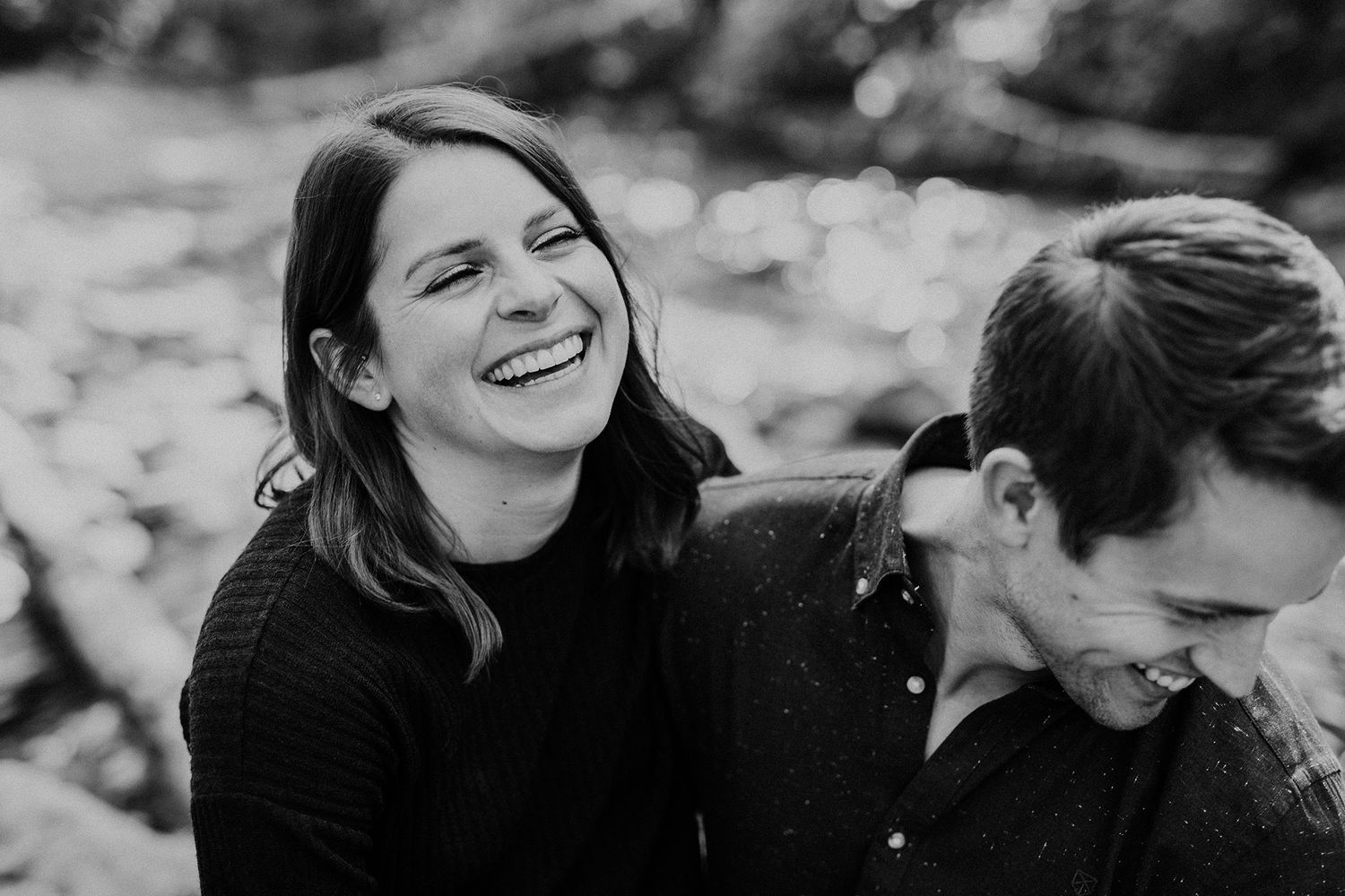 A black and white photo collage shows candid laughing moments between two people in an outdoor setting.
