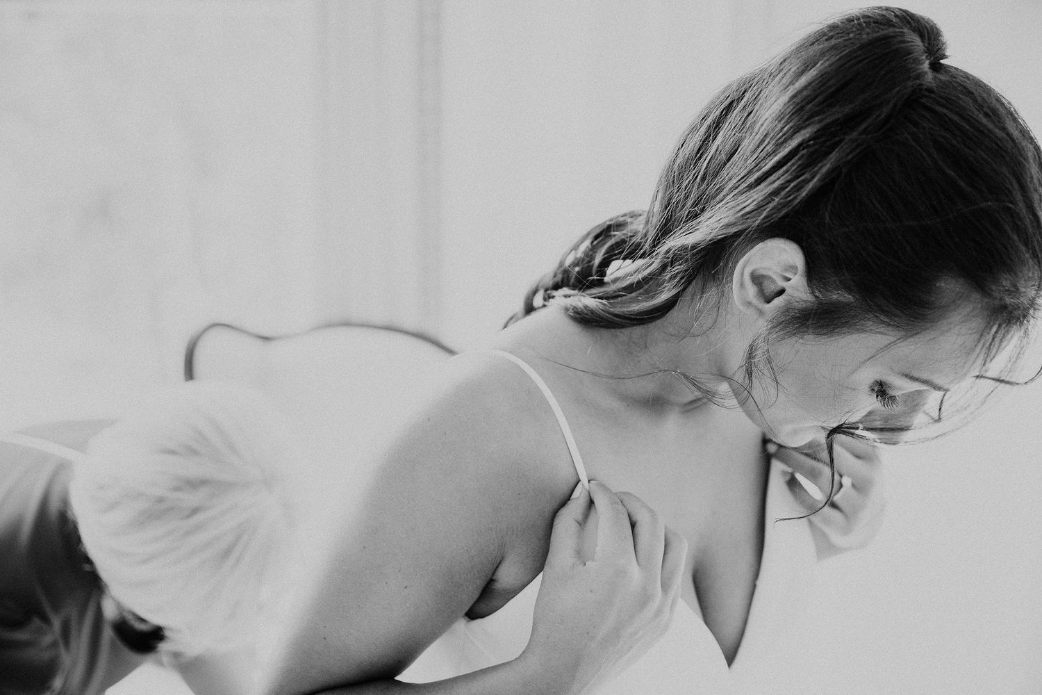 Black and white intimate wedding photos showing romantic moments between a couple in various candid poses.