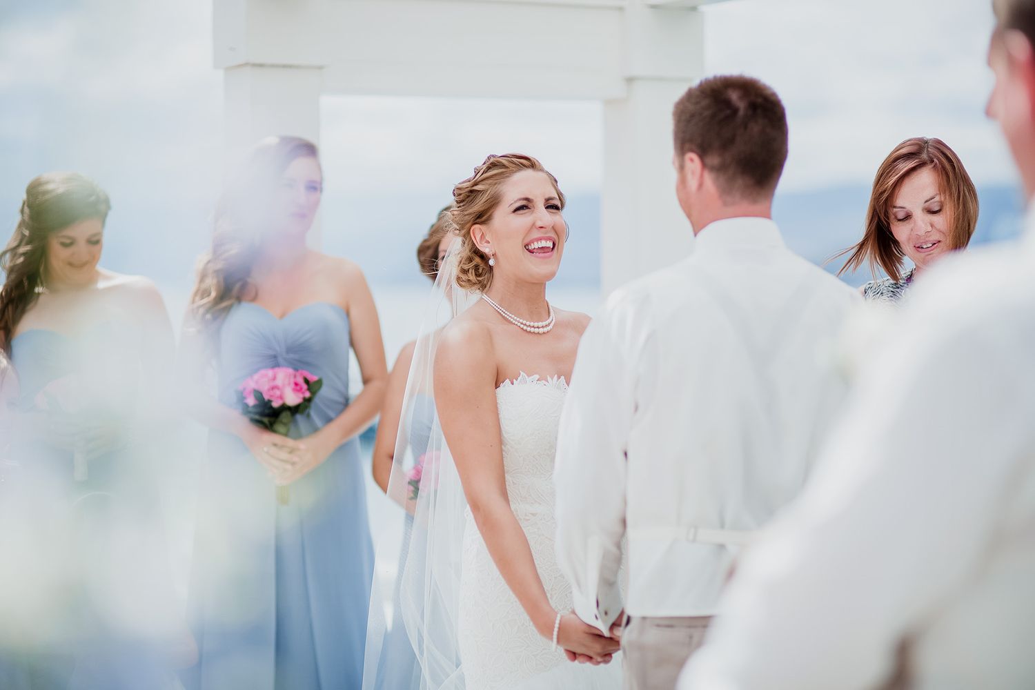 A wedding ceremony captured in a soft, dreamy style with pastel colours and natural lighting.