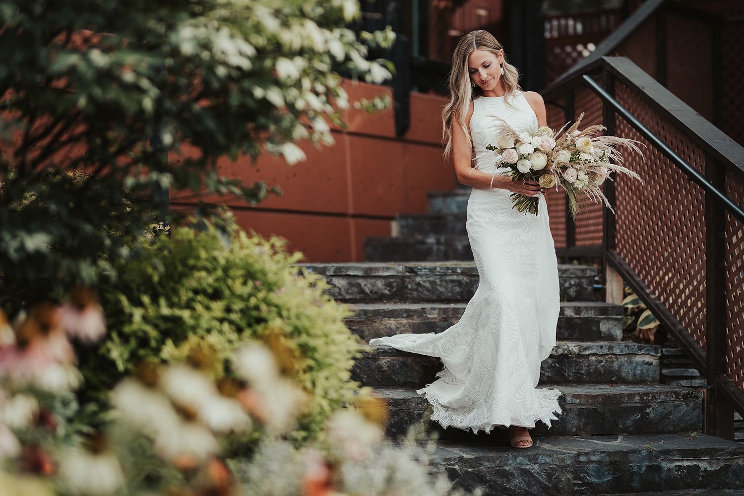 A bride descends stone steps during her wedding ceremony at Summerhill Pyramid Winery in Kelowna.