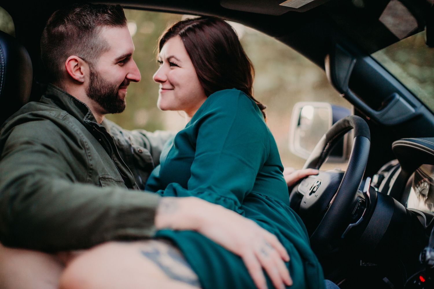 Candid moment of laughter and connection inside car interior.