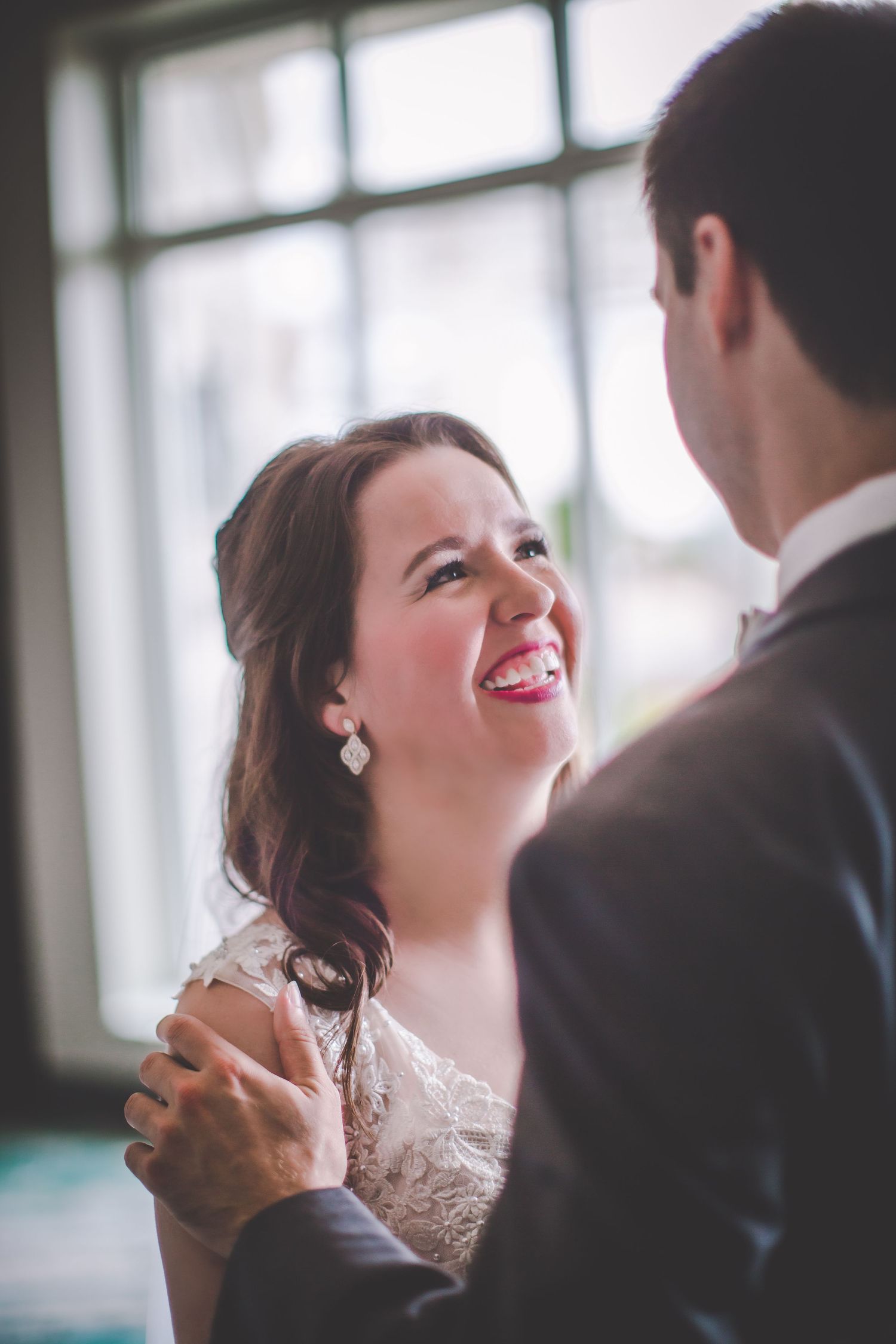 Two people share a joyful moment during their wedding celebration.