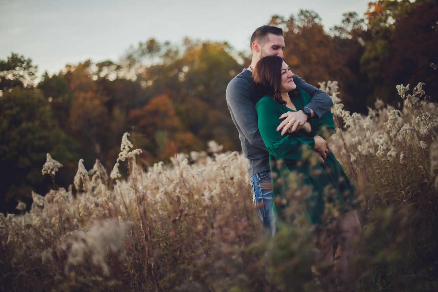 Candid romantic moment photographed in a golden field during autumn.