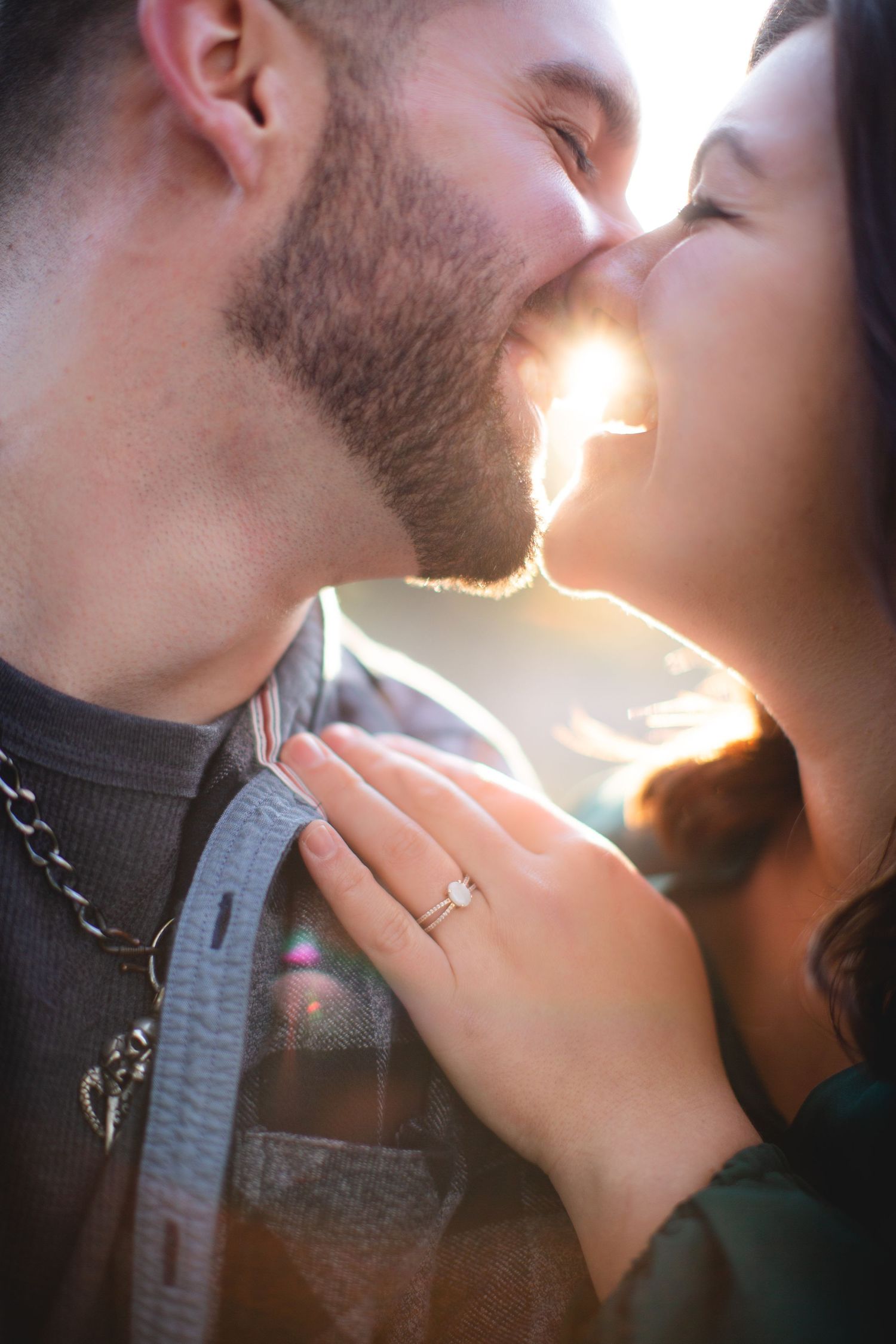 Close-up romantic portrait with sunlight creating rim lighting effect.