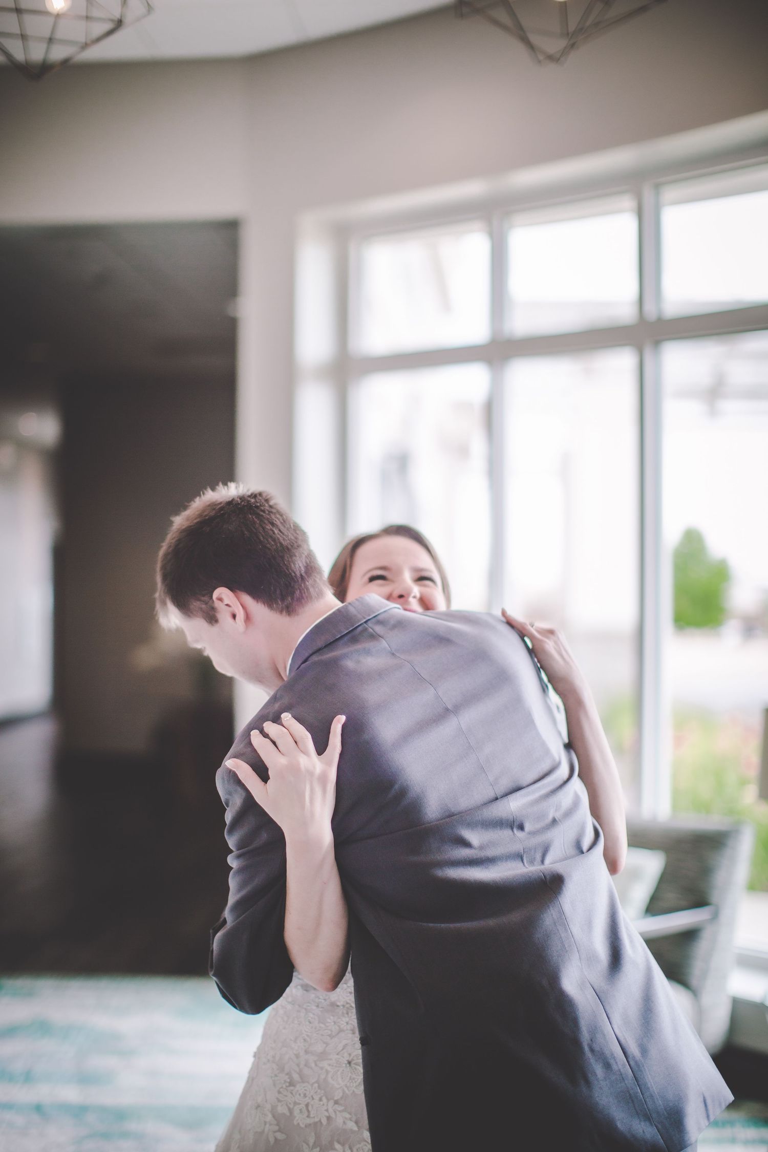 Candid first look wedding sequence showing tender embrace and reactions.