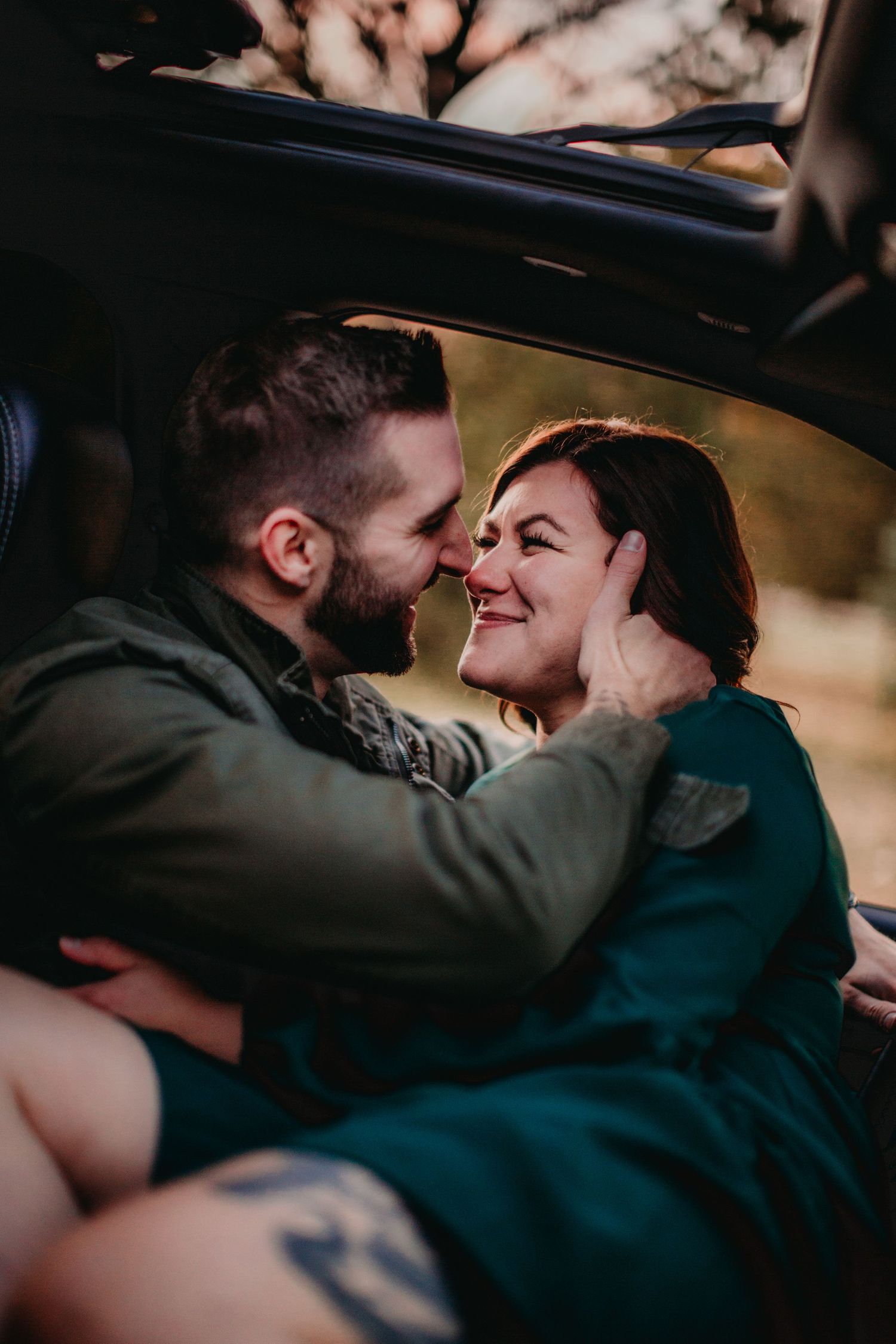 Intimate moment of joy and connection captured in car interior.