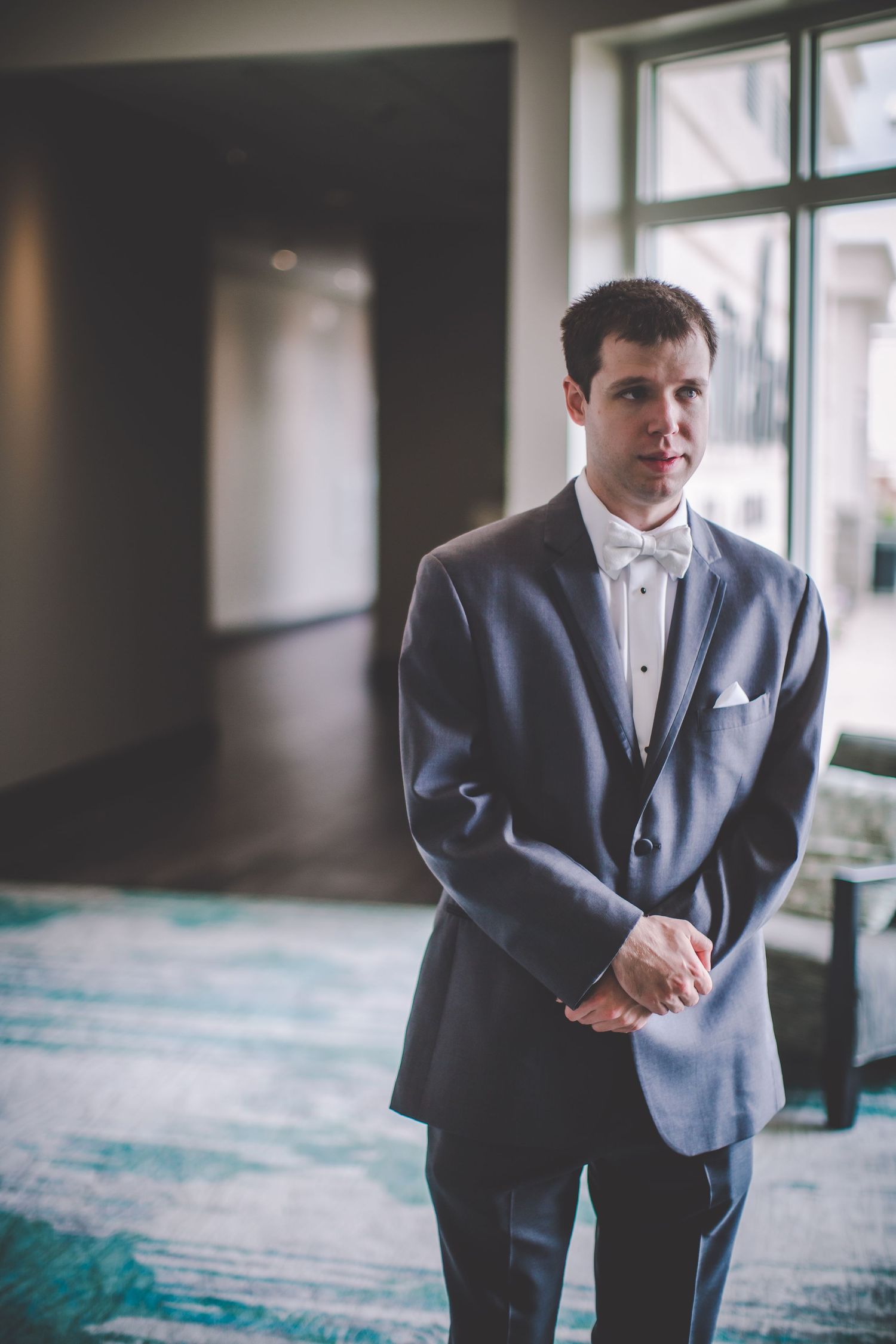 Wedding day portrait showing formal attire in an indoor venue setting.
