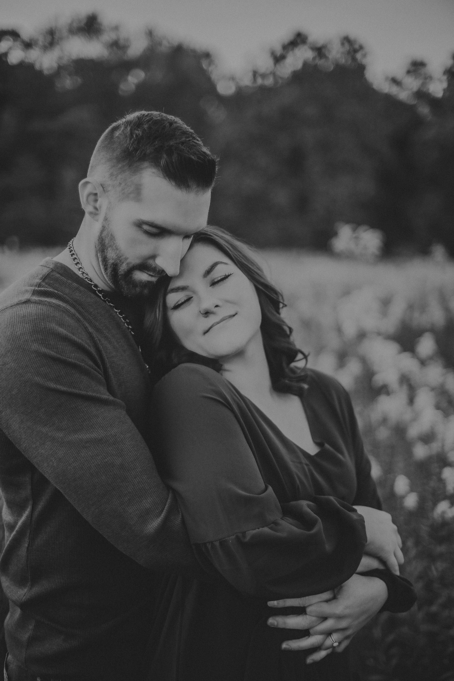 Intimate black and white portrait capturing tender moments in nature.