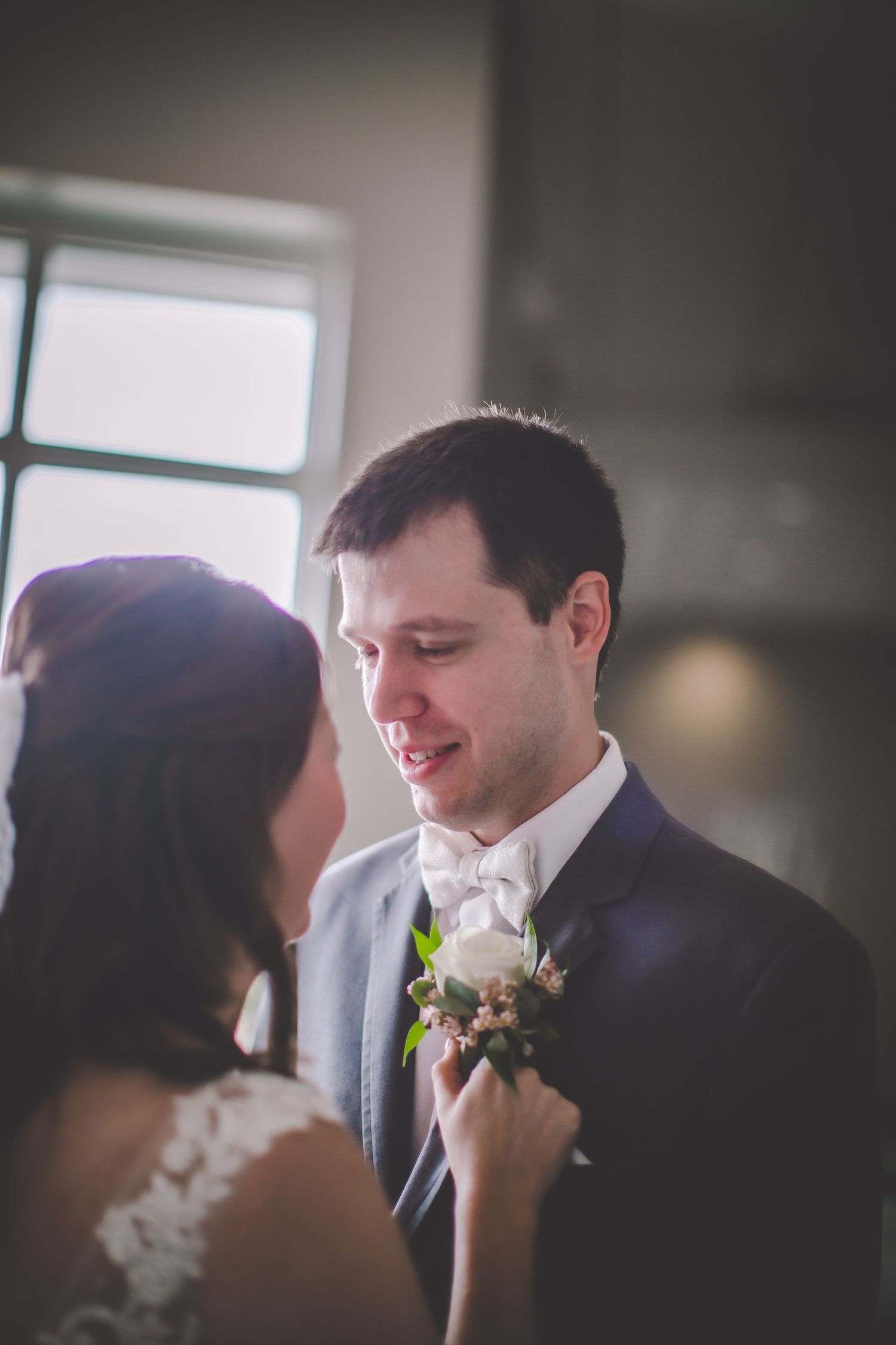 A gentle exchange between newlyweds as they share an intimate moment.