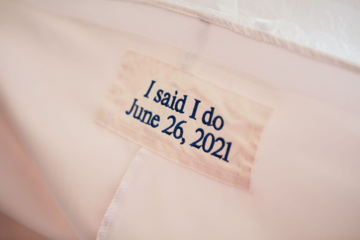 Wedding dress label showing 'I said I do' and June 2021 date embroidered in blue.