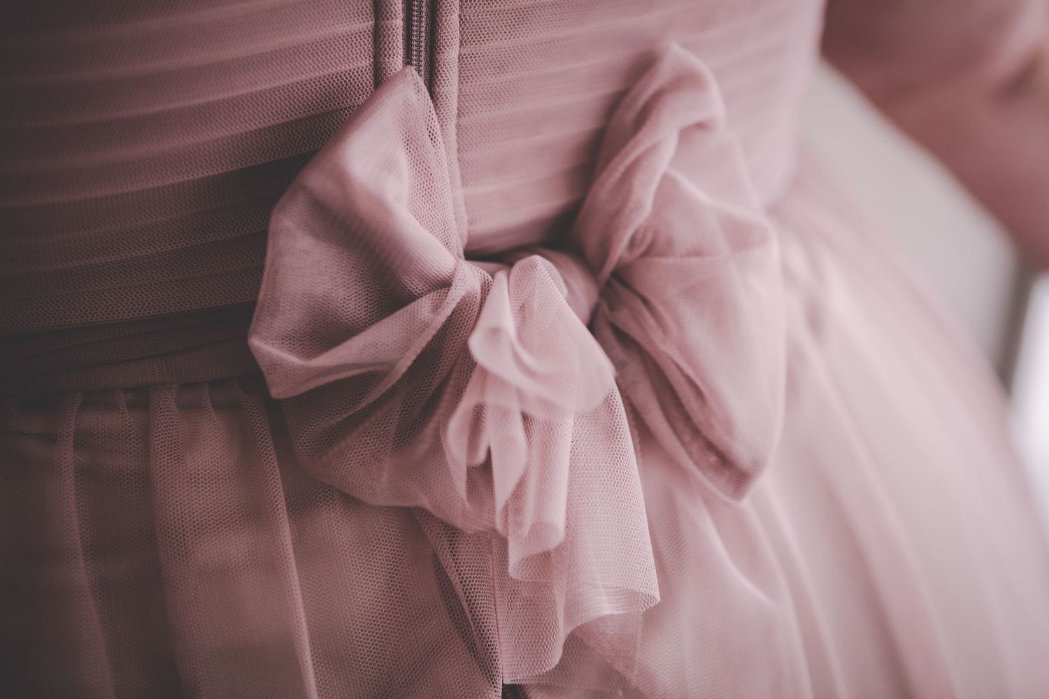 Pink tulle and fabric details of a romantic wedding dress.