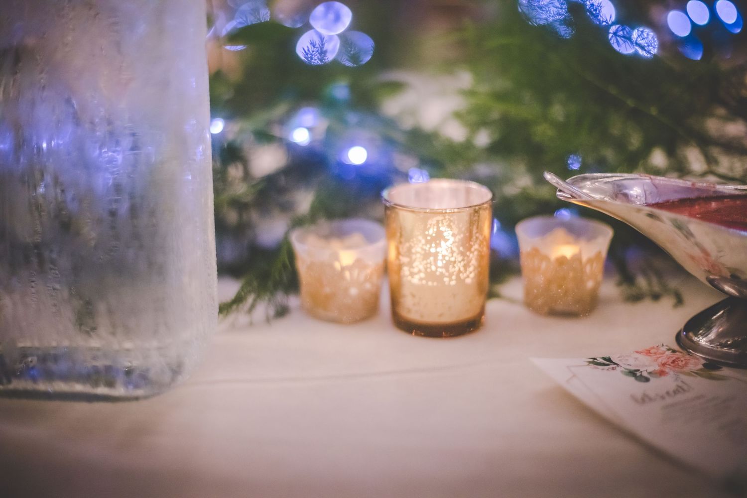 Romantic blue bokeh lights and candles creating an intimate wedding reception ambiance.