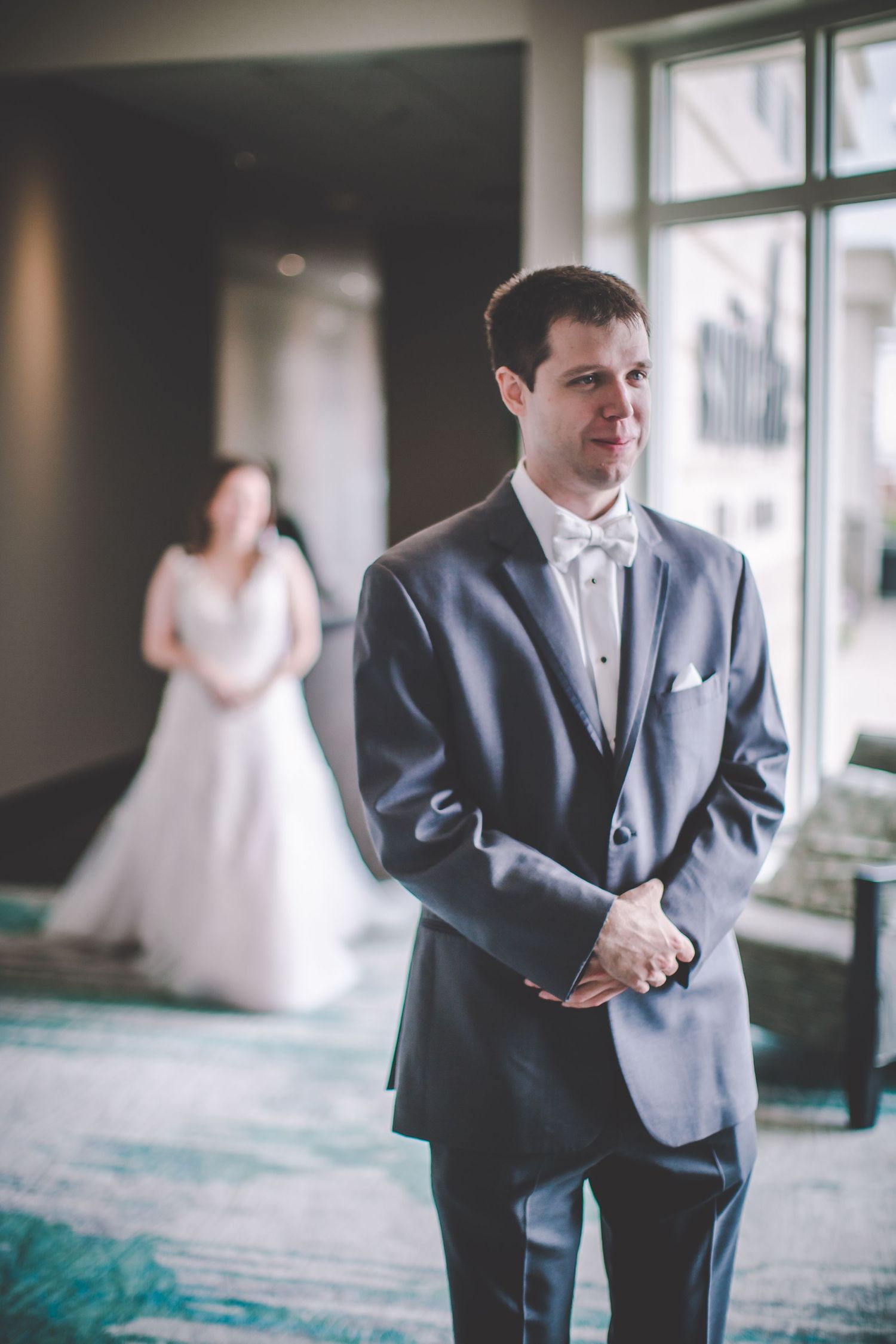 A sequence of wedding first look photos showing reactions and anticipation in a bright indoor space.