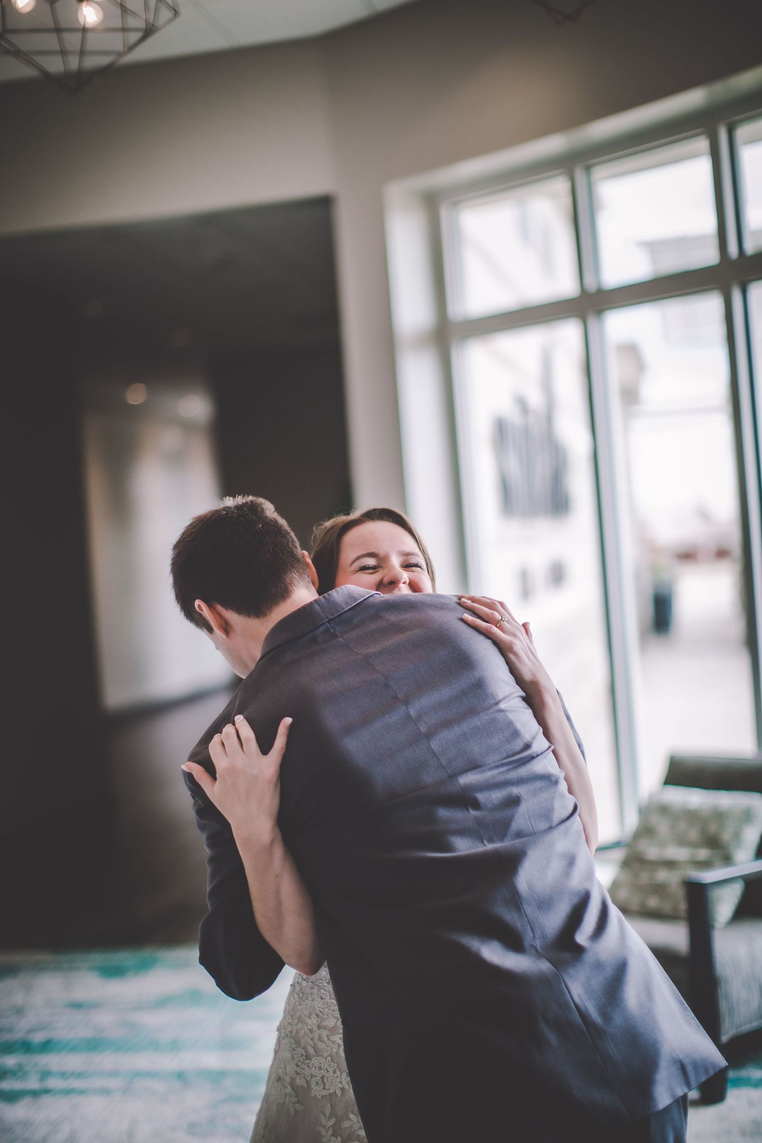 A tender moment captured as a couple hugs during their wedding celebration.