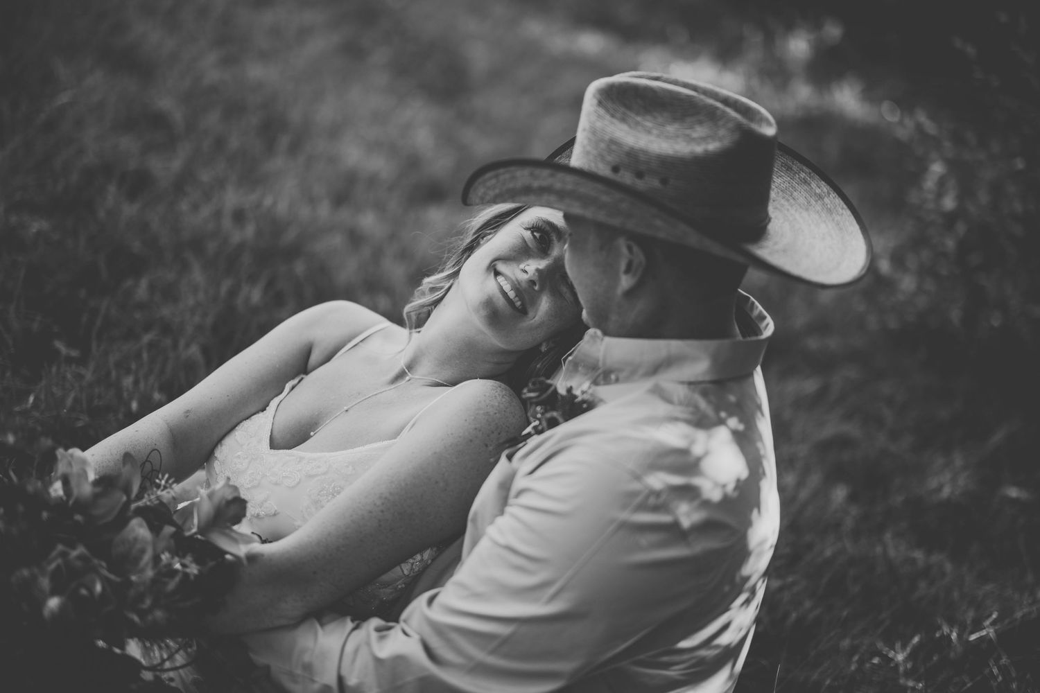 A romantic black and white photo series showing a couple embracing in a rustic outdoor setting.