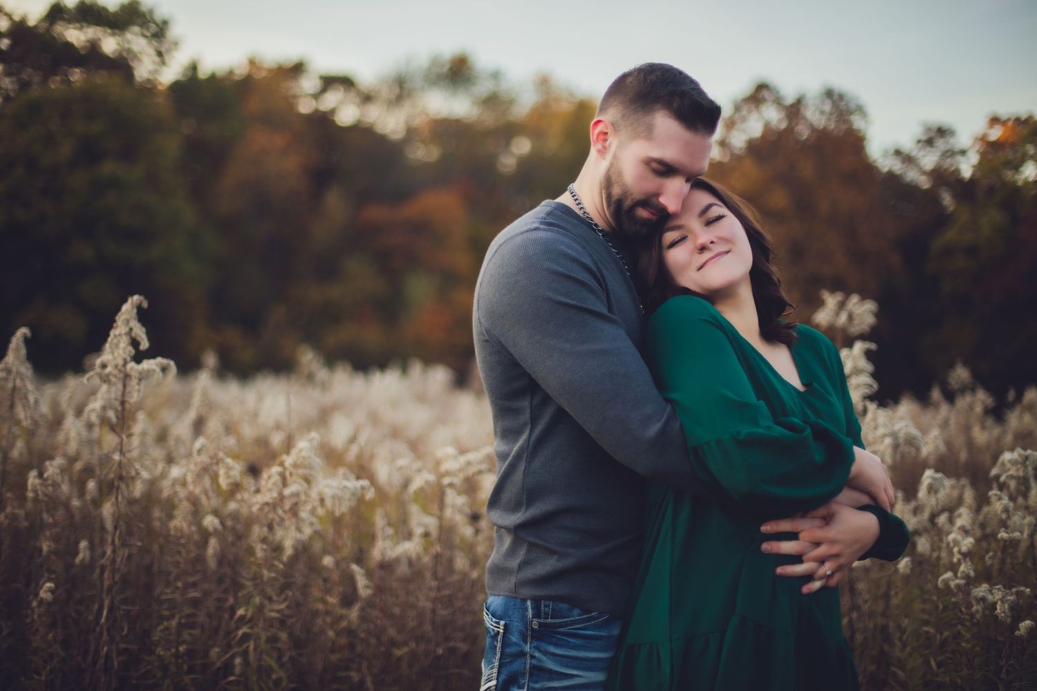 Romantic outdoor photography session captures tender moments in fall landscape.