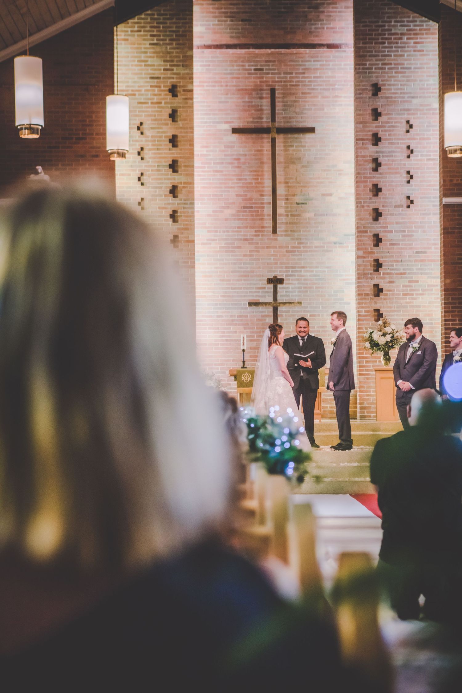 Interior view of a modern brick church during a wedding ceremony.