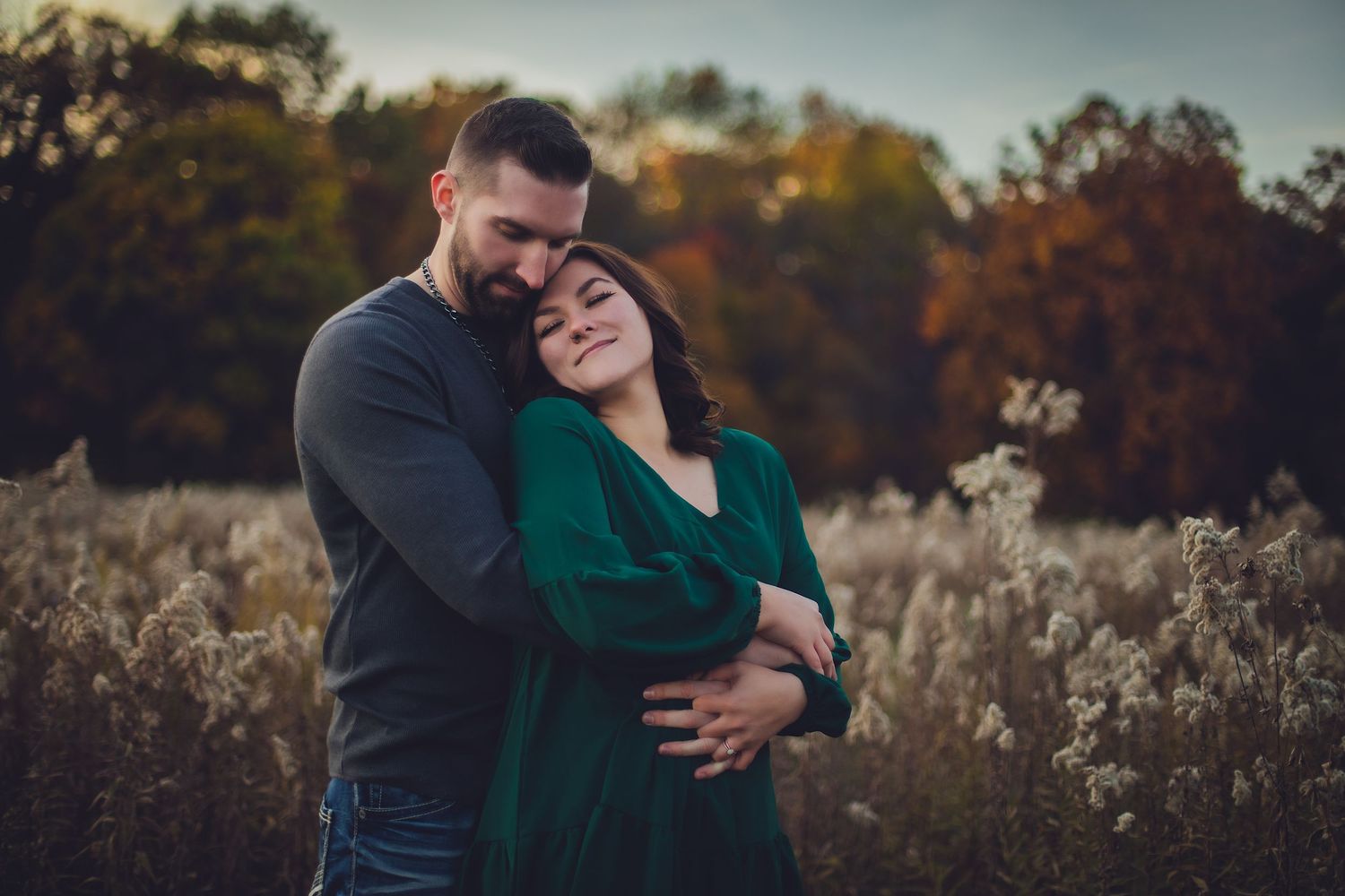 Emotional outdoor portrait session amid autumn's natural beauty.