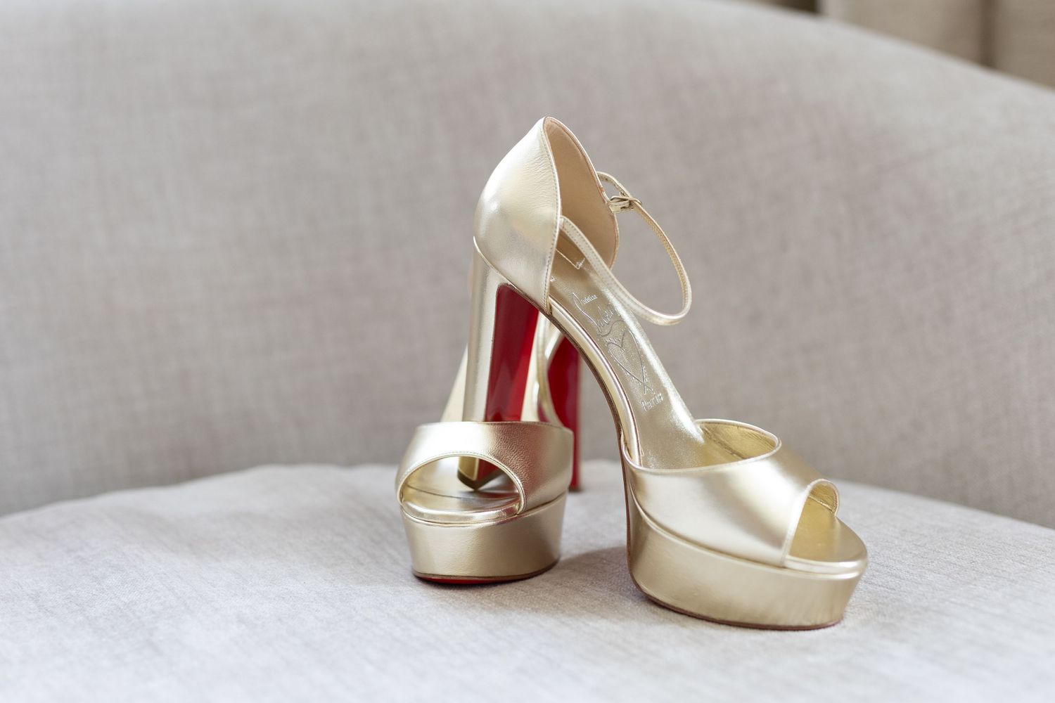 White bridal heels arranged in a row on a light gray surface.