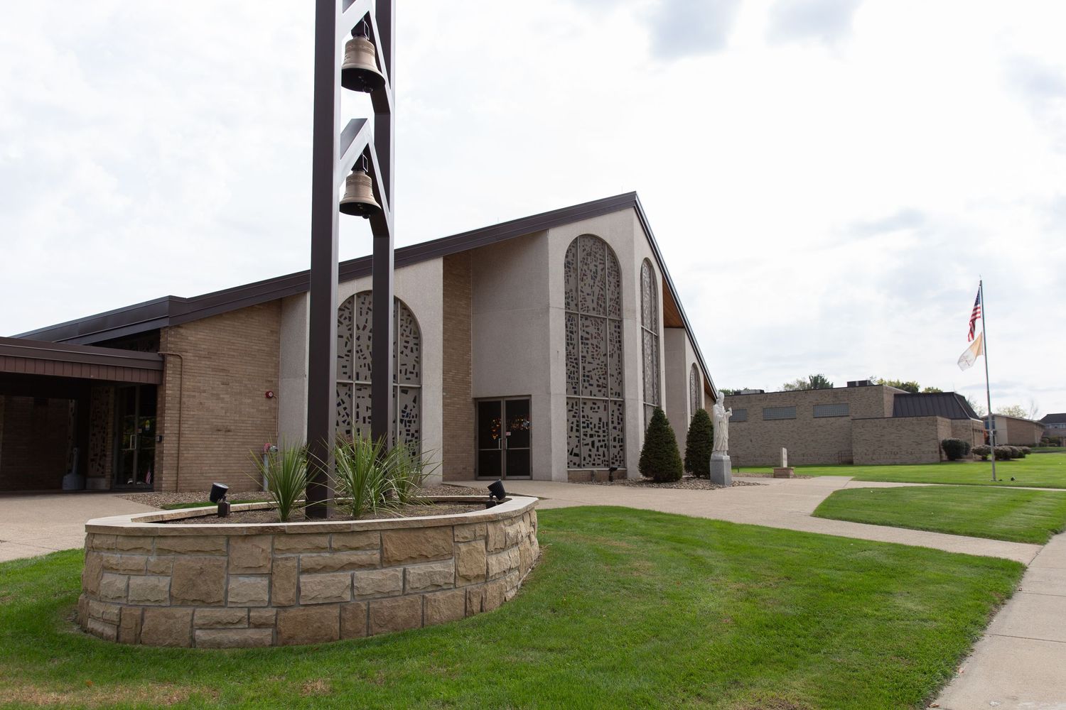 Exterior view of a modern church building with stone accents and architectural details.