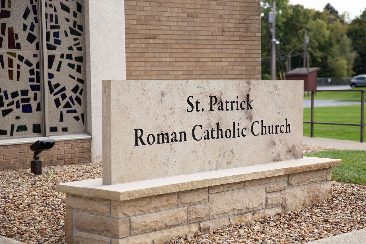 Stone sign and entrance way of St. Patrick Roman Catholic Church building.