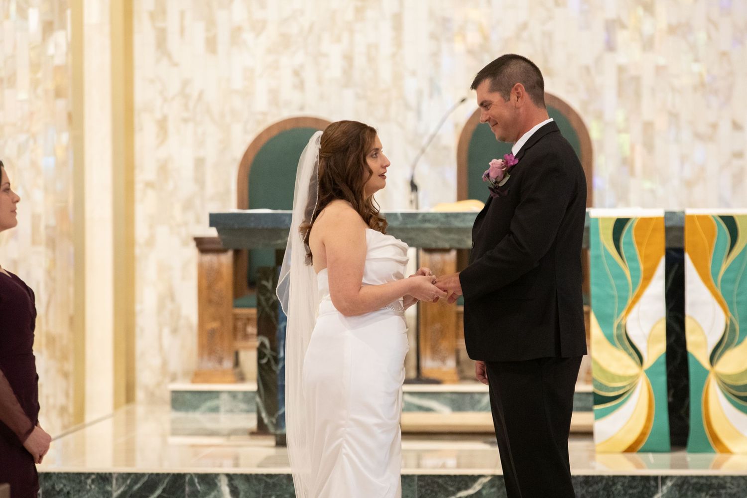 Wedding couple exchanging vows at the altar during their ceremony.