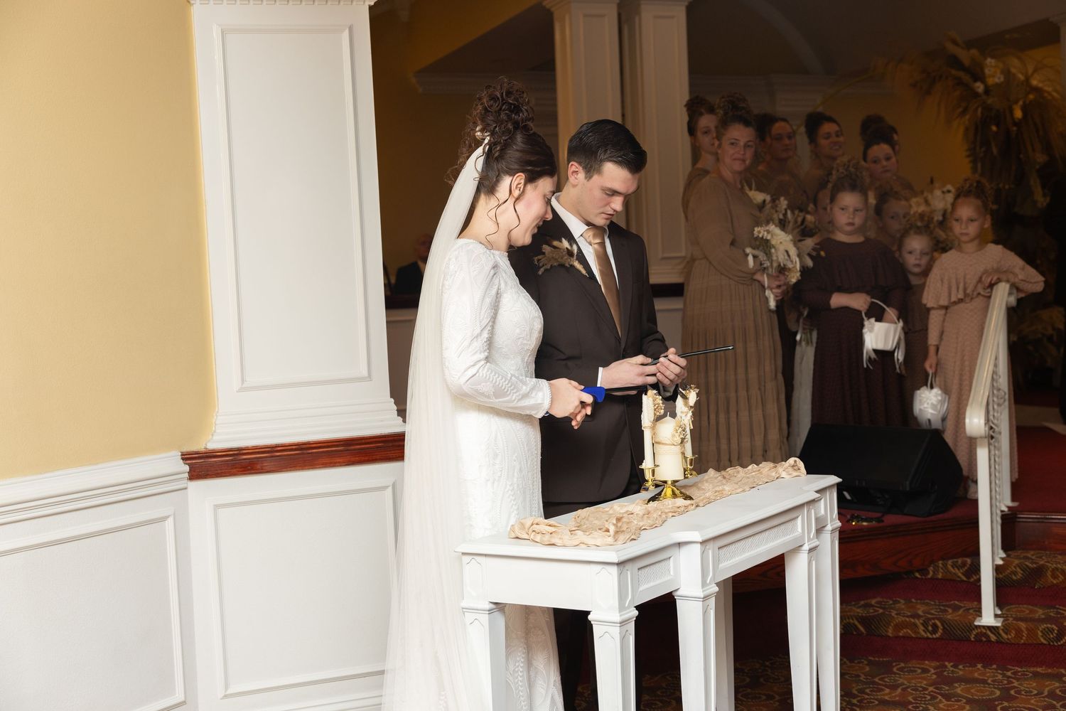 Wedding ceremony venue with white columns and elegant architectural details.