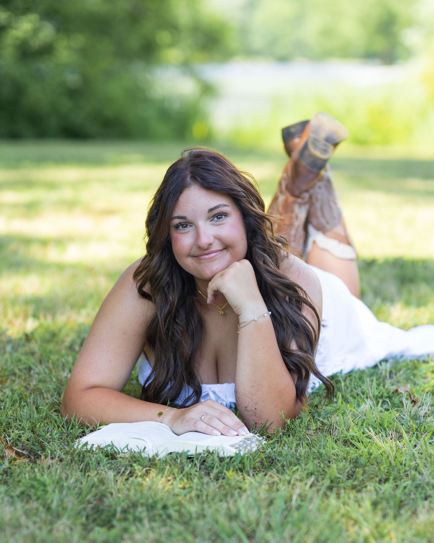 A relaxed outdoor photo session on green grass with soft natural lighting.