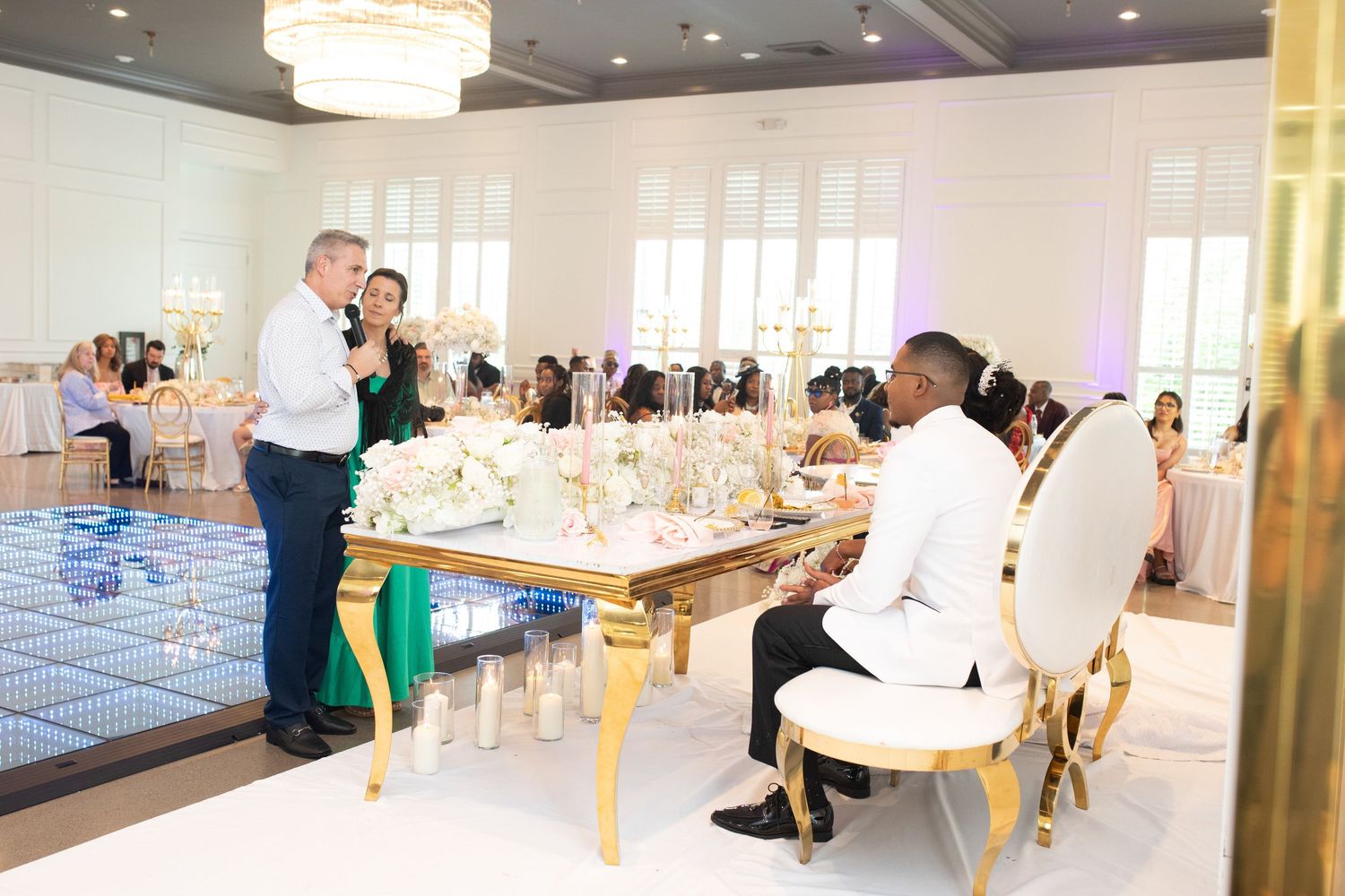 Wedding reception venue with elegant gold tables and chairs set for celebration.