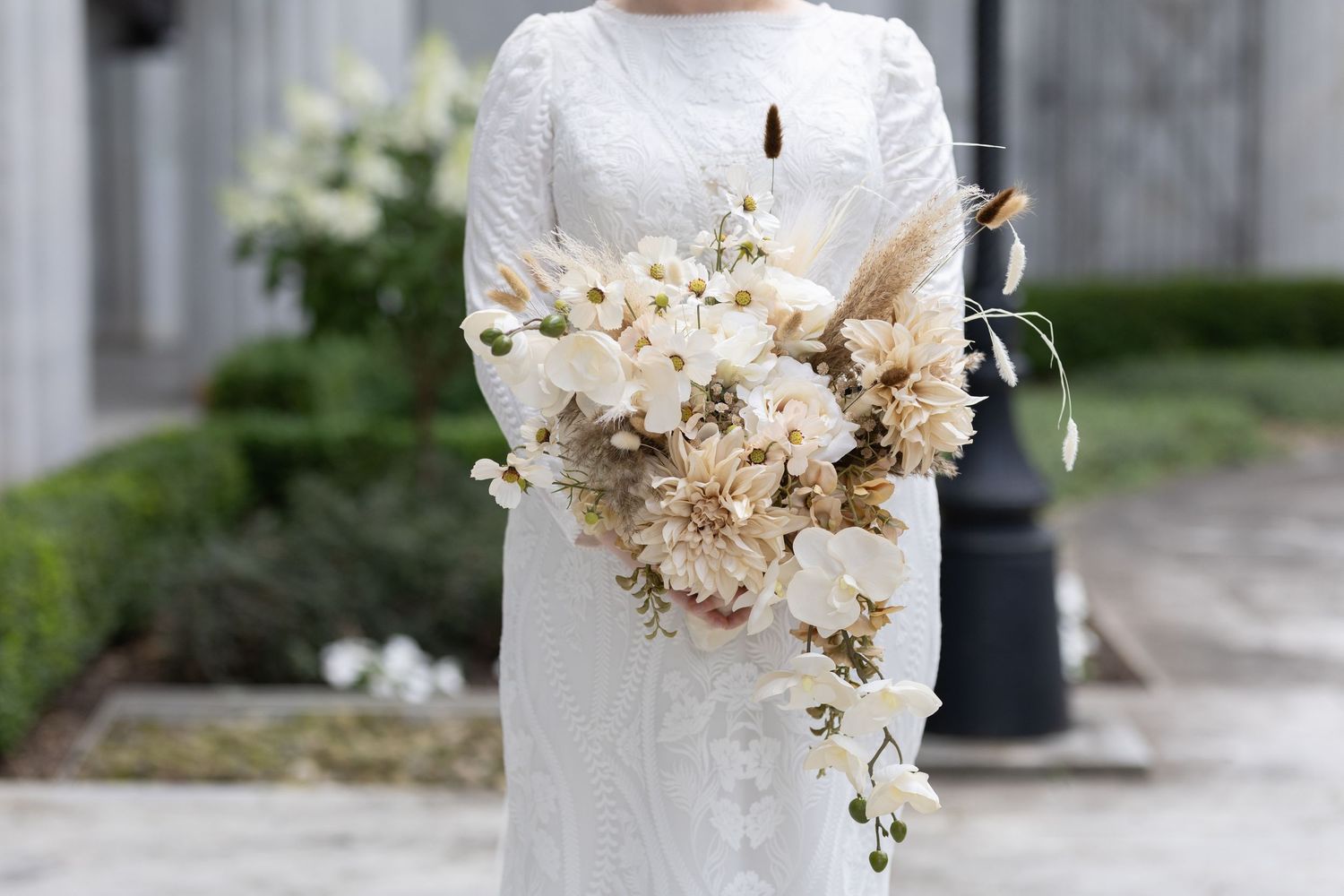 Close-up of elegant dried floral wedding bouquet with neutral colors and pampas grass.
