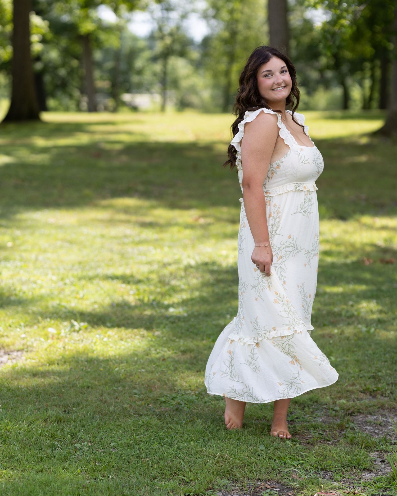 Summer outdoor photography session in a sunlit grassy park setting.