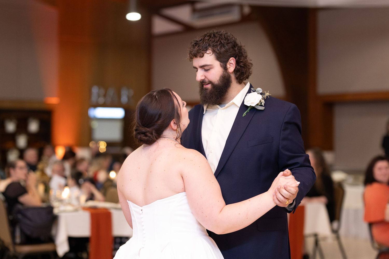A couple shares their first dance at their wedding reception.
