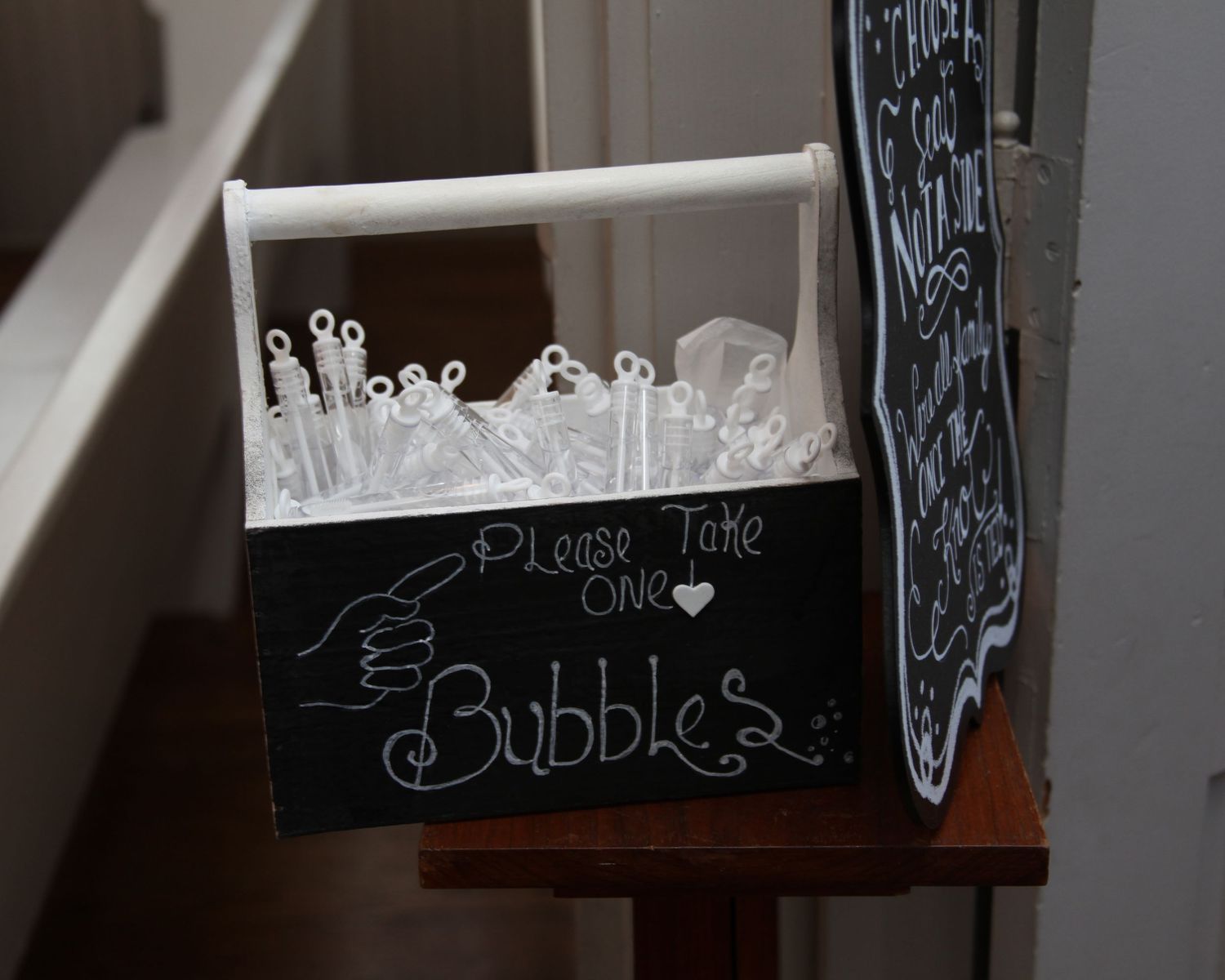 Chalkboard sign for wedding bubbles display with glass bubble wands.