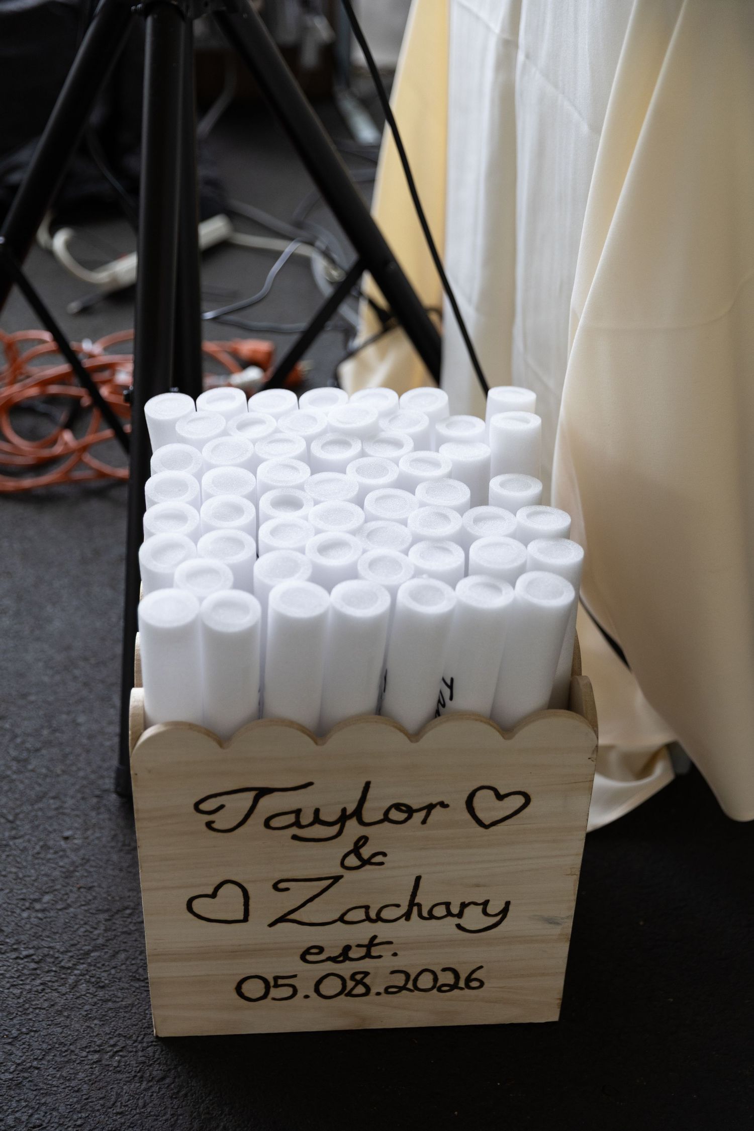 Wooden box with white unity candles engraved with Taylor & Zachary est. 05.08.2026 for a wedding ceremony.