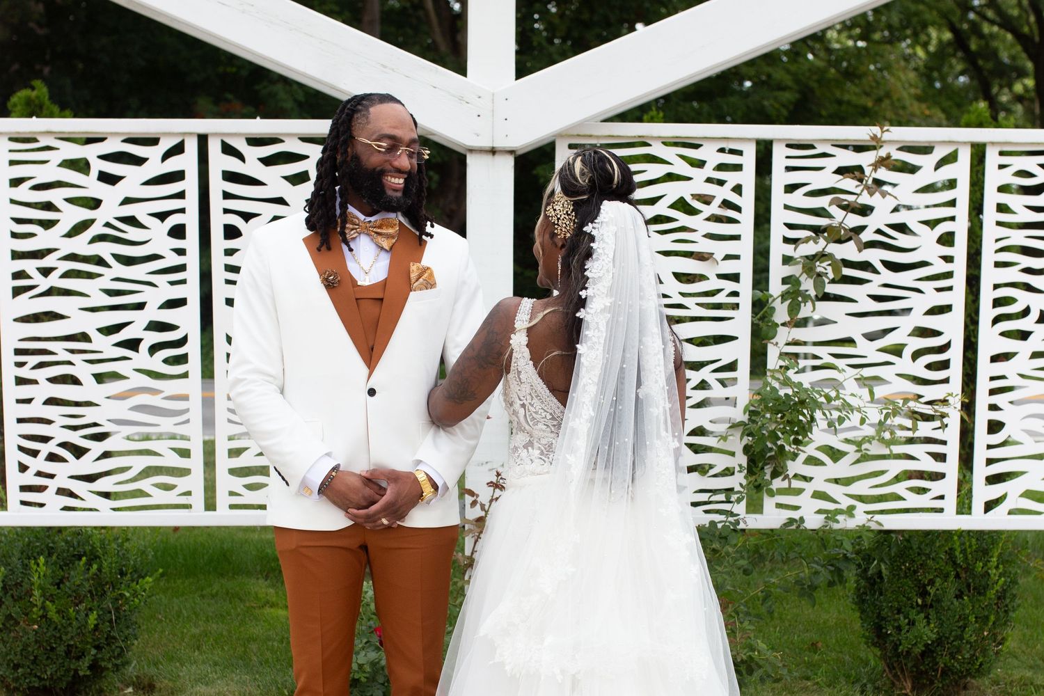 A white lattice fence serves as a backdrop for an outdoor celebration.